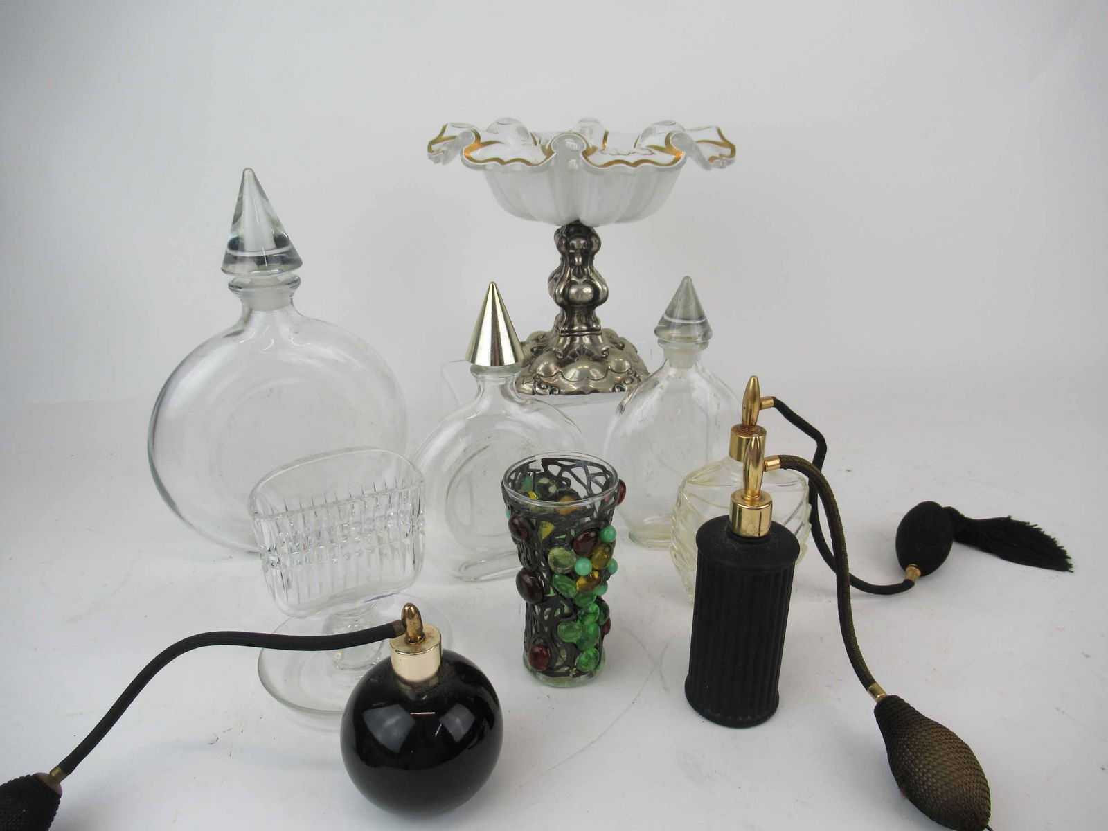Silvered Footed Glass Compote: Silvered Footed Glass Compote. Together with a silver overlay vase, perfume atomizers and Guerlain perfume bottles. Used condition, wear, worn, missing labels, chip to compote.