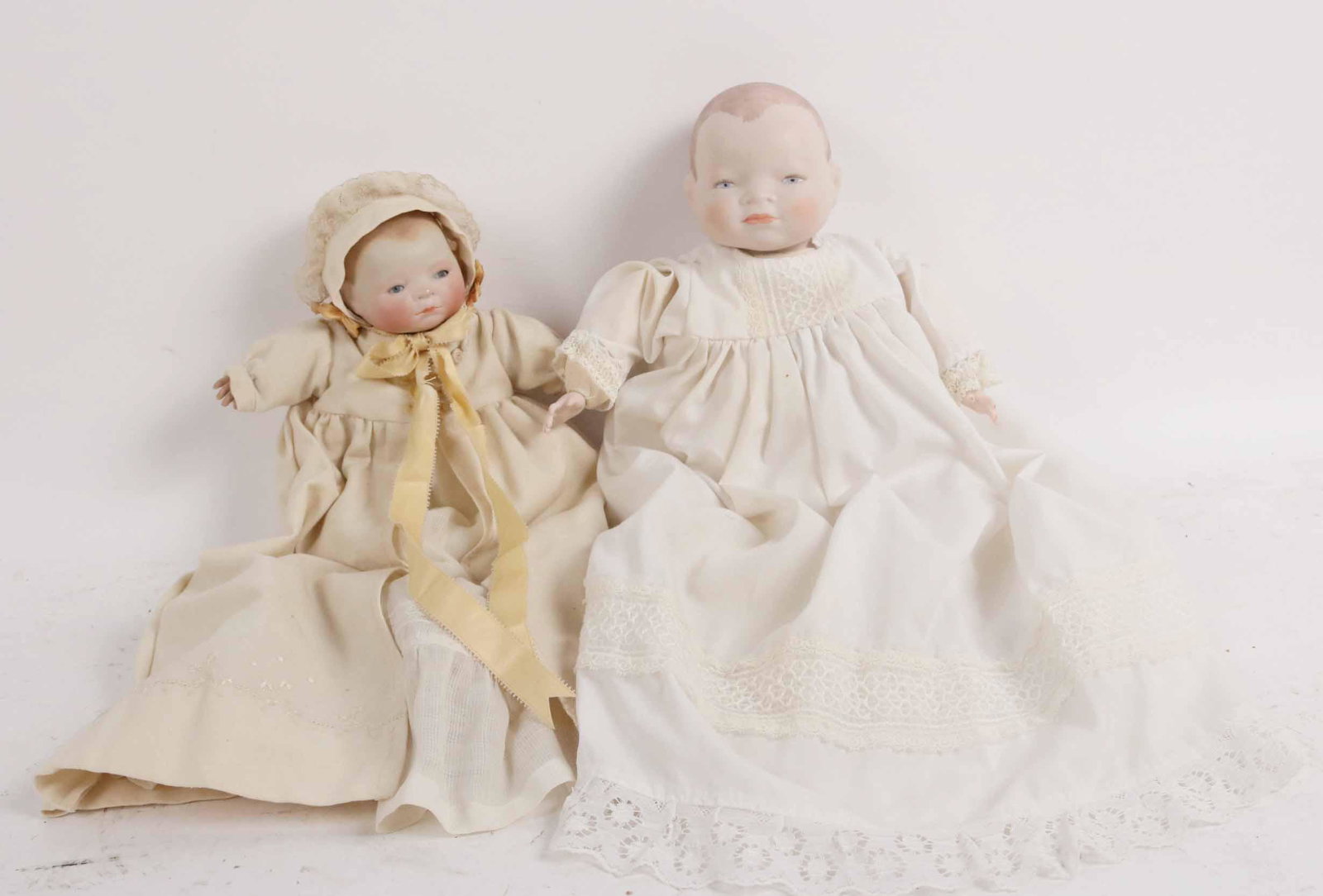 Grace S Putnum Bye lo Baby Doll: Circa 1923. Re-painted bisque head, sleeping blue eyes, celluloid hands. Together with a bisque head and hands baby doll. Size:Grace S. Putnum 9" head circumference.
