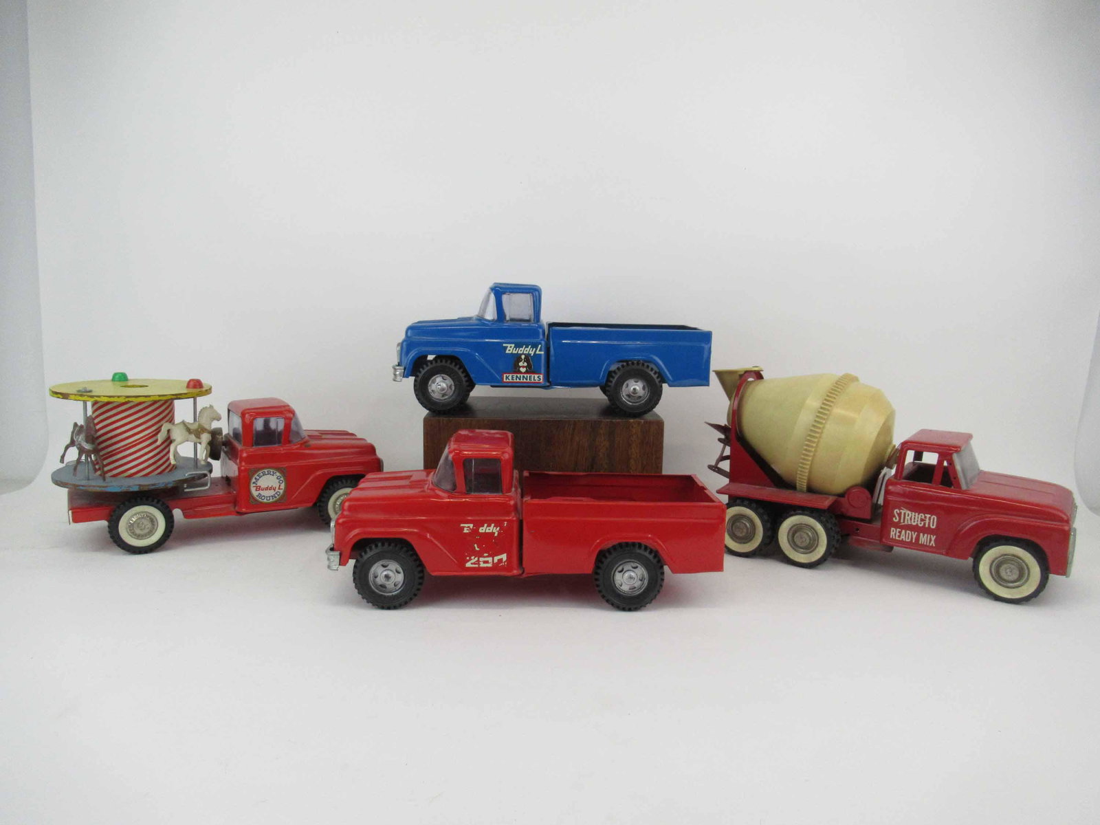 Group of Assorted Vintage Buddy L. Toy Trucks: Group of Assorted Vintage Buddy L Toy Trucks. Including Merry Go Round Carousel, Buddy Zoo, Buddy Kennel and a Structo Ready mix truck. Used condition, wear, worn, maybe missing pieces.
