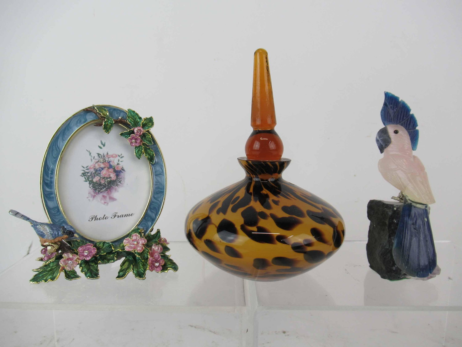 Carved Rose Quartz Cockatoo With Amethyst Geode: Carved Rose Quartz Cockatoo With Amethyst Geode together with an art glass tortoise shell perfume bottle and a Jay Strongwater style enameled picture frame with bluejay and flowers; used condition, we