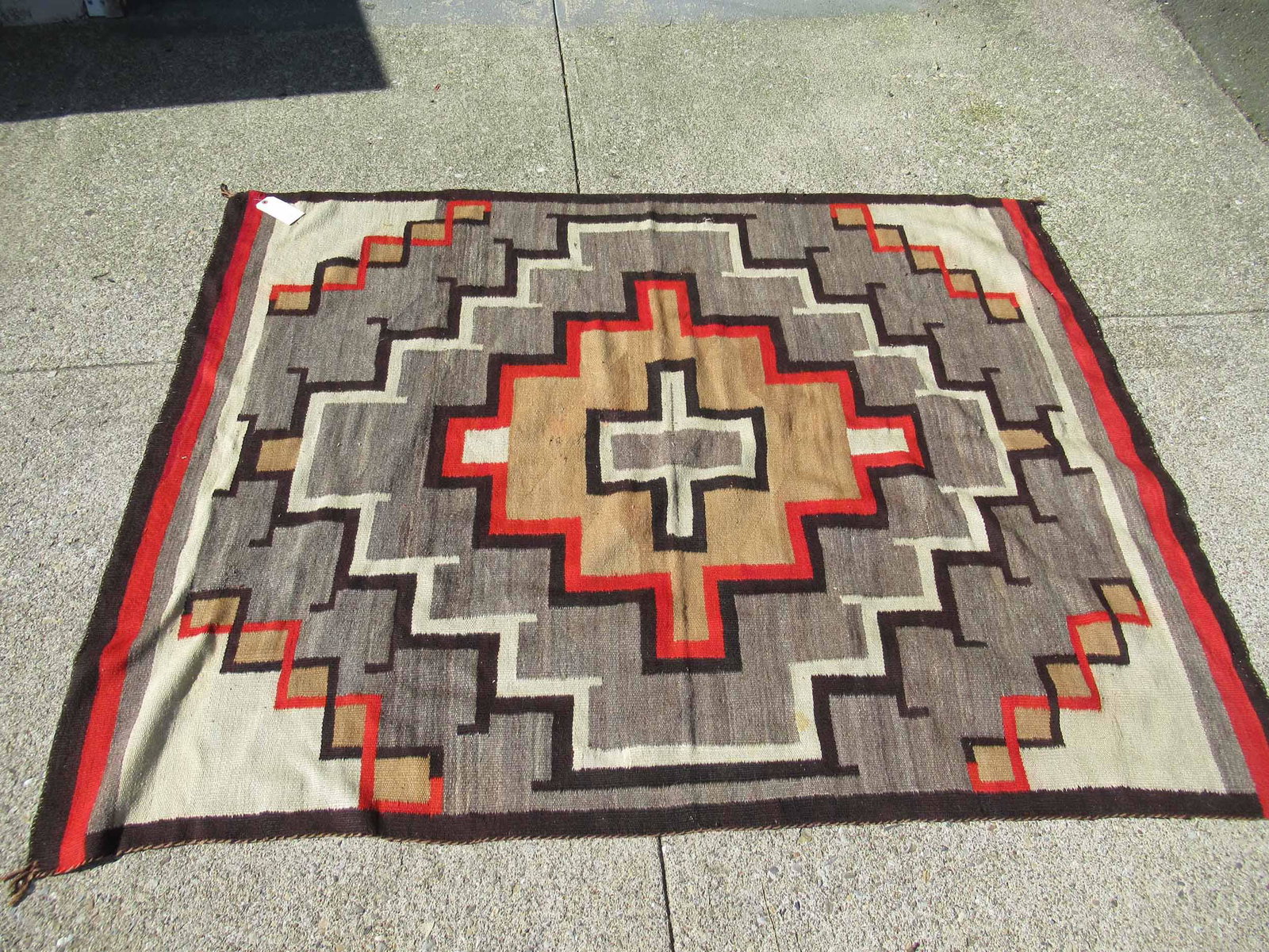 Native American Throw Rug: Native American Throw Rug with central cross form medallion. Used condition, wear, worn, holes, tears. 7'4" x 5'7"