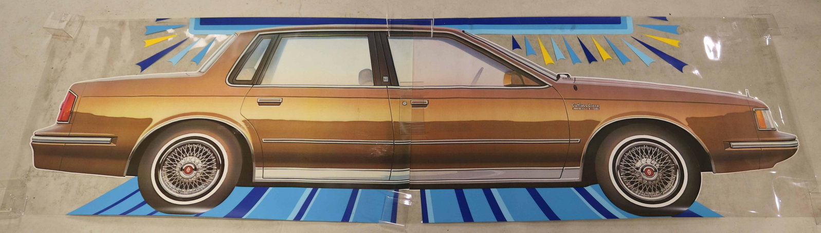 Celluloide Car Advertising, Oldsmobile Cutlass: Oldsmobile Cutlass Ciera, c. 1984, in 4 pieces. Cracks, scratches and wear. Overall apx. 4'6-12"h x 11'4"l Please Note: Photographs of the consignor are not included with this lot. They are only inclu