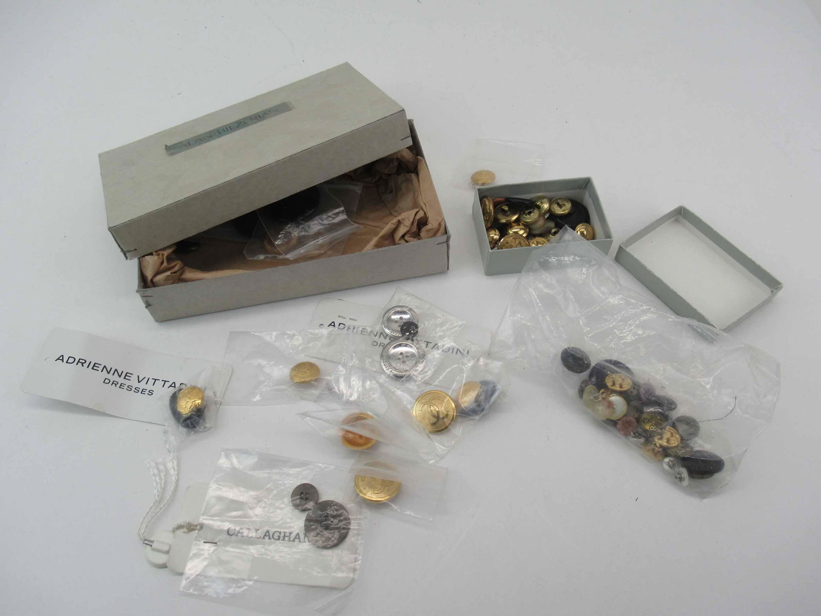 Vintage Designer Buttons, Chanel and Vittadini: Ralph Lauren and more in a small cardboard Alan Bilzerian lidded box.