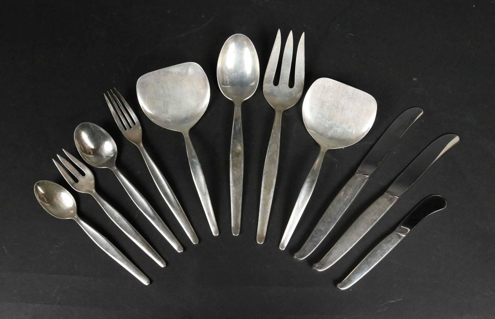 Towle Sterling Silver "Contour" Pattern Flatware: Comprising: Serving fork, spoon and two spatulas. Seven dinner forks, seven salad forks, six cocktail forks, one condiment forks, six soup spoons, thirteen teaspoons, seven butter knives, seven knives
