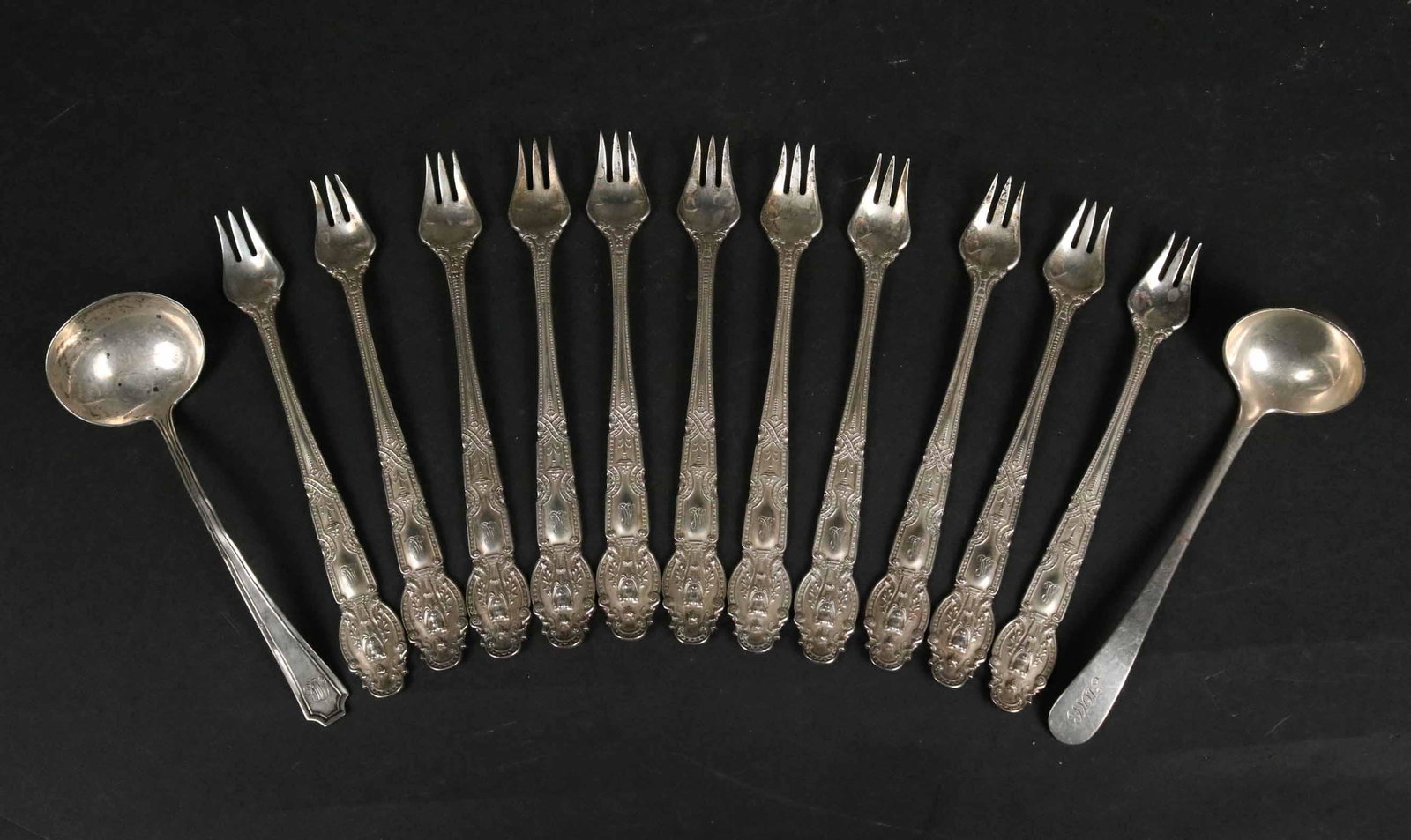 Tiffany Sterling "Renaissance" Oyster Forks: Eleven oyster forks. Together with a Tiffany sterling silver "Reproduction Edinburough" ladle and a Gorham sterling silver ladle. Apx. 11 t.o. Provenance: Property from the Estate of Margaret Hull Cha
