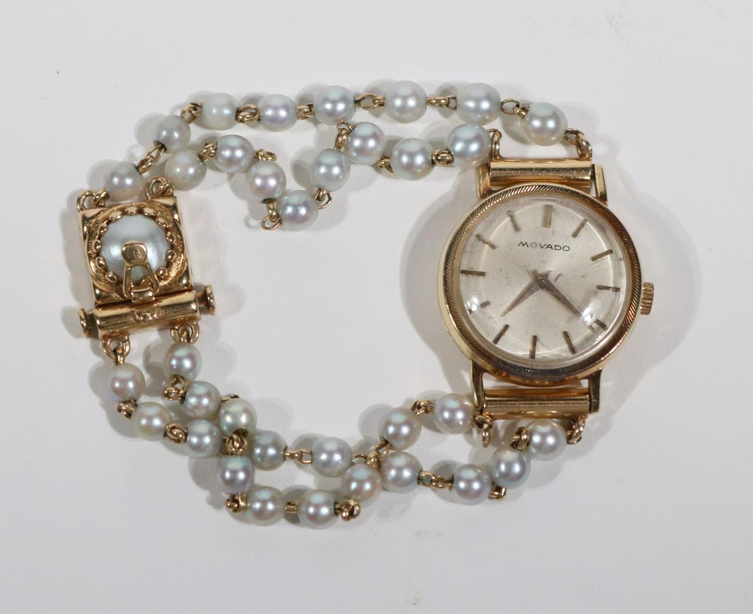 Movado 14K Yellow Gold Pearl Bracelet Ladies Watch: Circular dial silvered dial with gilt numeral indicators, double strand small pearl bracelet band, dial worn, crystal scratched, 6-1/4"l.