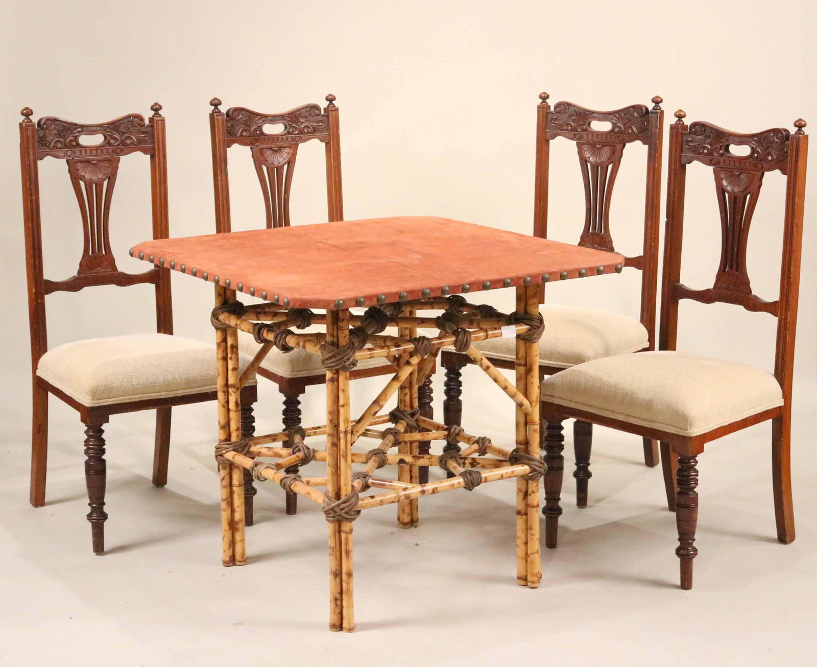 Victorian Leather and Bamboo Games Table: Probably English, 19th C. Together with four carved cherrywood side chairs, c. 1900. Table: 30-1/2"h x 34"w x 35"d Chairs: 42"h