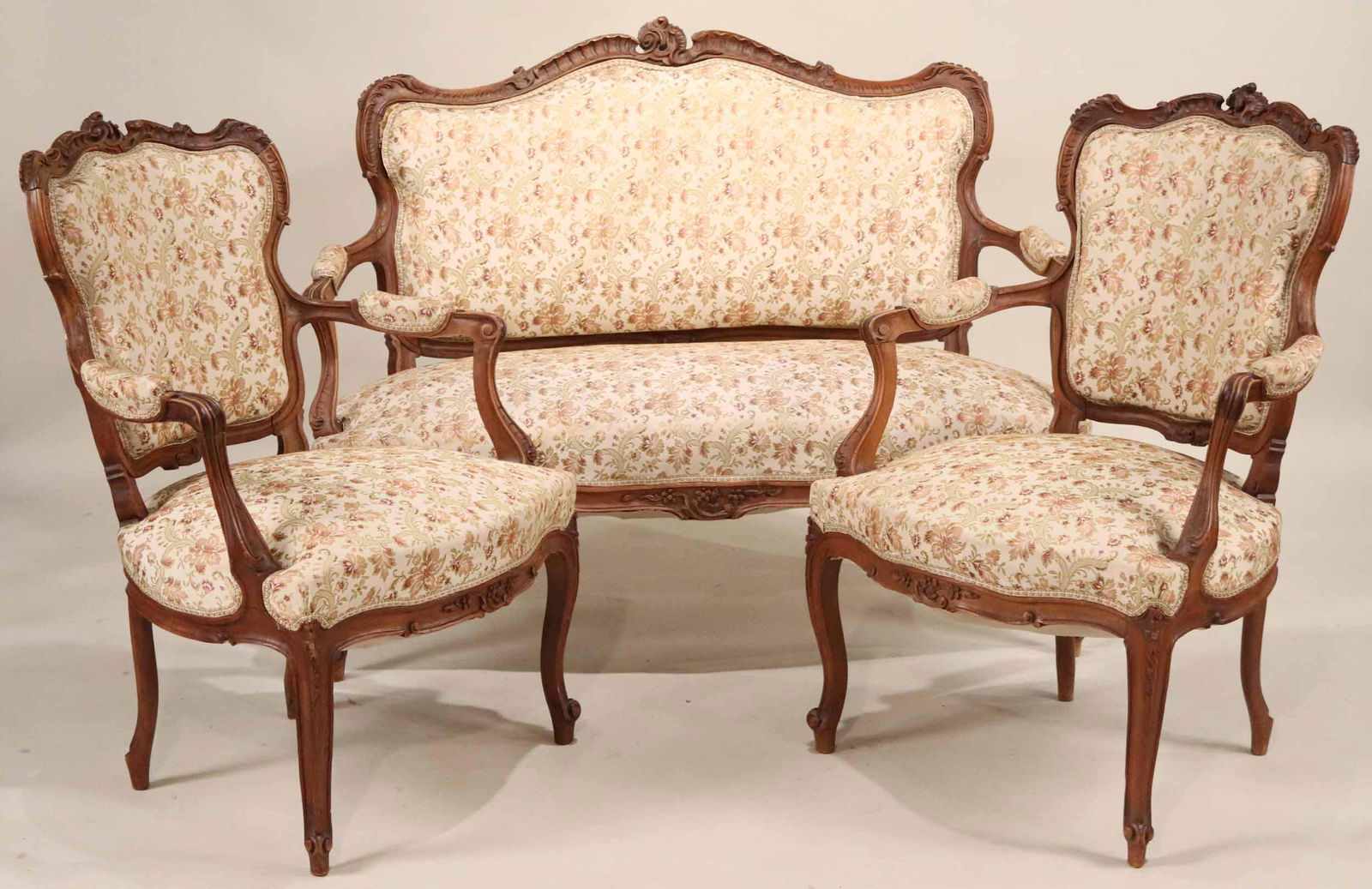 Louis XV Style Carved Walnut Seating Suite: French, 20th C. comprising two armchairs and a settee. 3 pieces Settee: 38"h x 48"w x 24"d Armchairs: 37"h