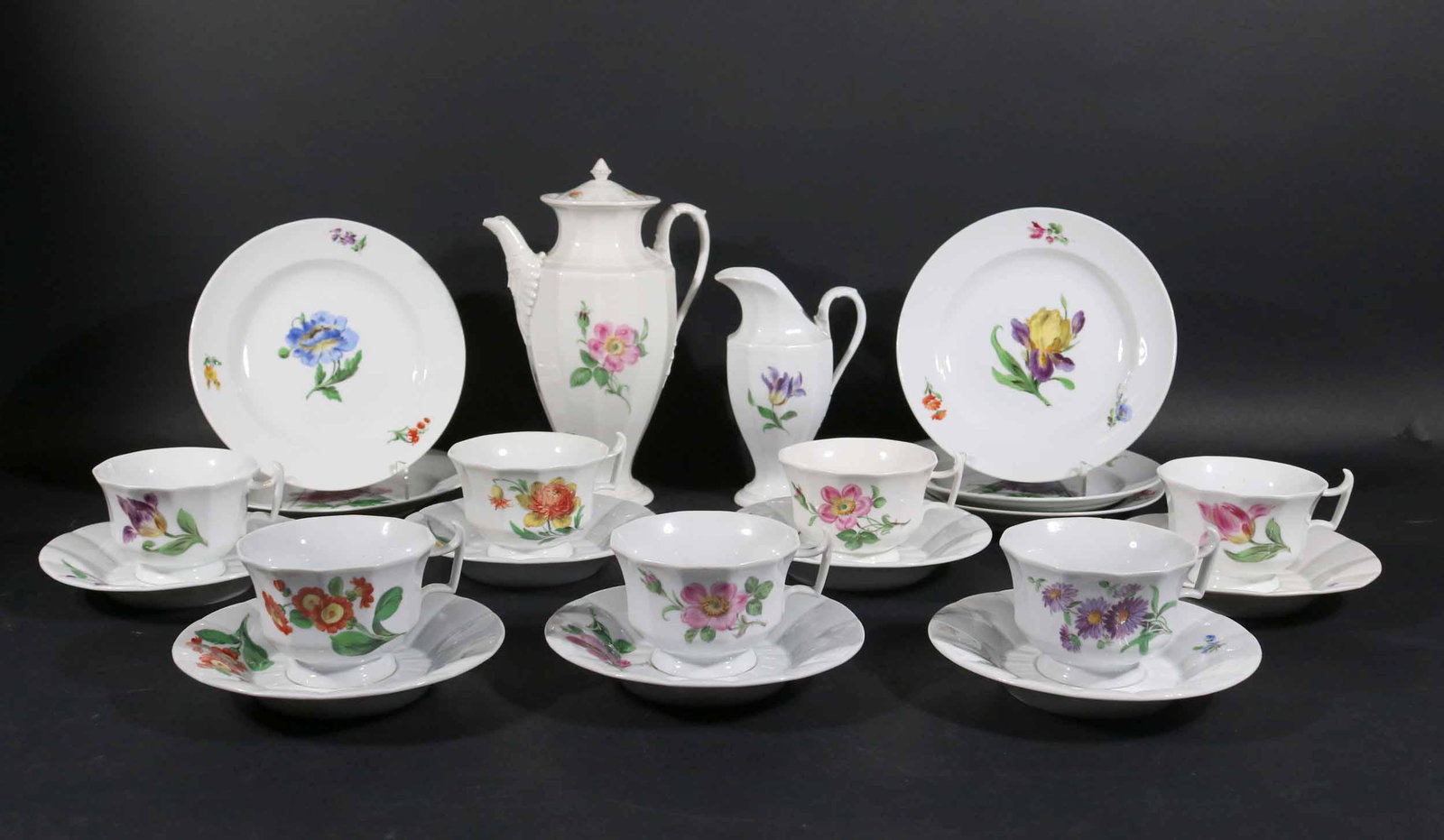 Meissen Floral Porcelain Tea and Dessert Service: Comprising, 7 cups and saucers, a creamer, teapot, and five small plates. 21 pieces Some chips.