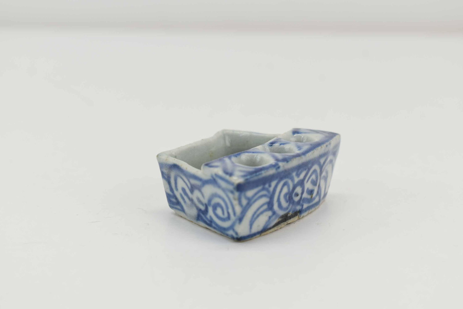Antique Chinese Porcelain Pen or Brush Holder: Antique Chinese Porcelain Pen or Brush Holder of triangular form with three holders and wash basin having blue and white floral decoration; used condition, wear/worn, measures 2 1/2" long x 1" high x 