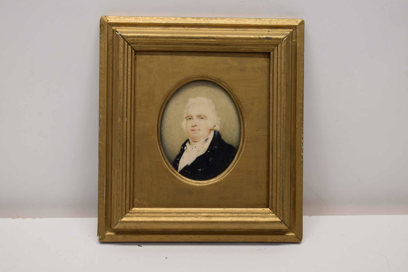 Antique Portrait Miniature of Gentleman: Antique Portrait Miniature of Gentleman in Blue Coat on bone. Used condition, wear, worn, missing back. Framed size 6 1/4" x 5 3/4"