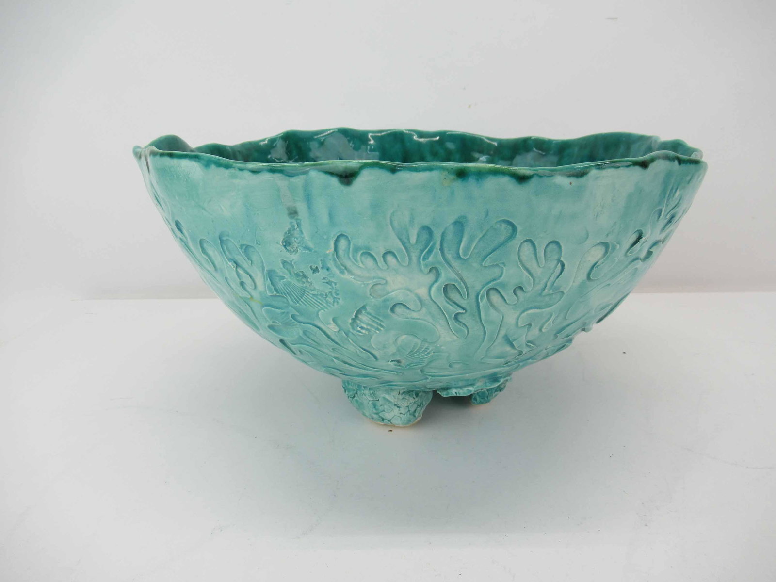 La Romana Pottery Turquoise Footed Bowl: La Romana Pottery Turquoise Footed Bowl having impressed seashell design; used condition, wear/worn, measures 12" in diameter x 6 3/4" high