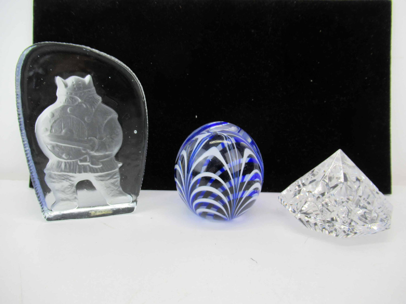 Waterford Crystal Diamond Shaped Paperweight: Waterford Crystal Diamond Shaped Paperweight in the Lismore pattern, etched Waterford, together with a blue egg shaped paperweight stamped MMA and a clear Viking Warrior pressed glass paperweight; use