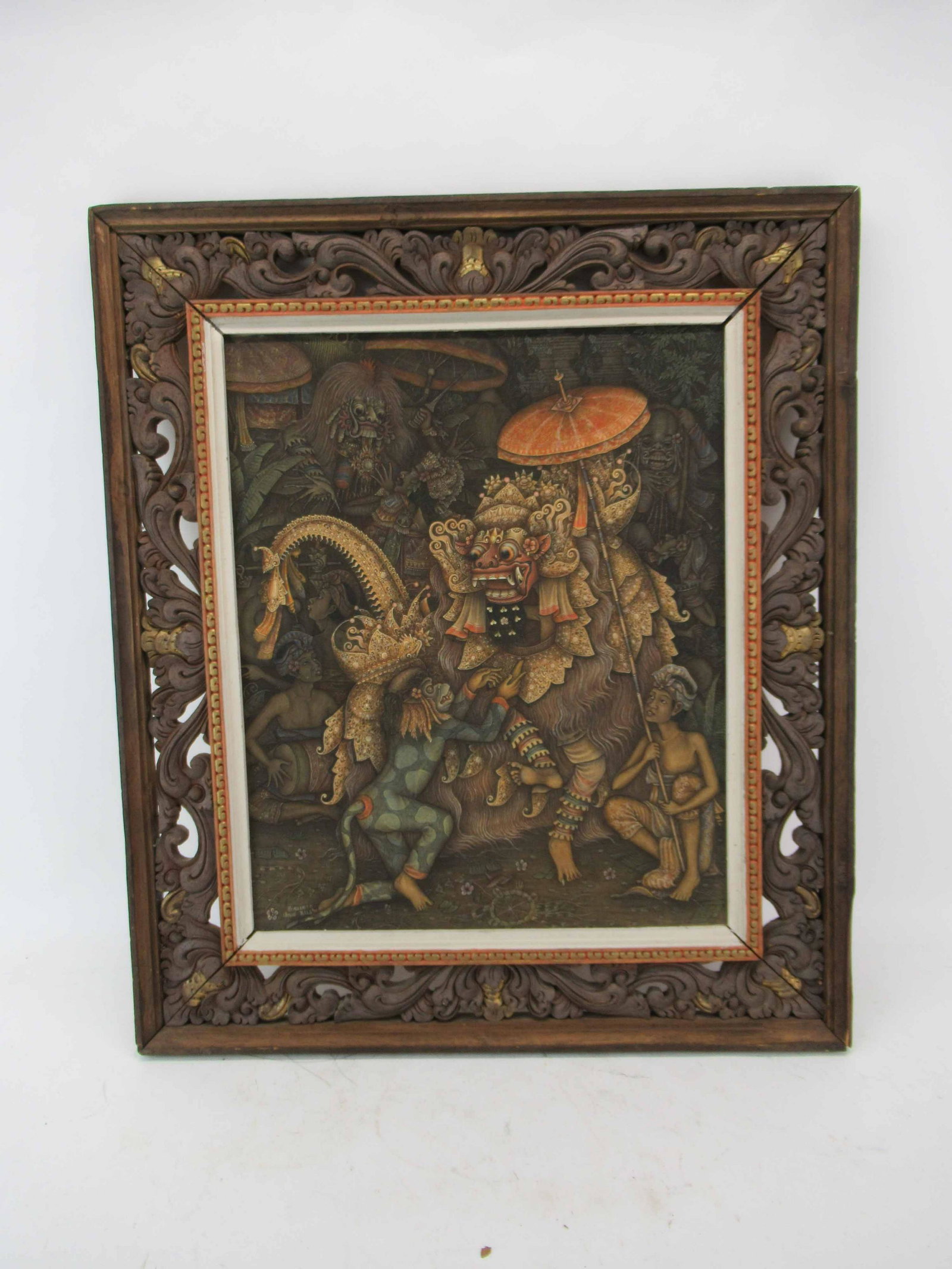 Sudiarta Painting on Fabric Canvas: Sudiarta Painting on Fabric Canvas depicting Indonesian dragon diety scene. Signed lower left Sudiarta Ubud Bali. Mounted in ornate wooden carved frame. Used condition, wear, worn, frame worn and may 