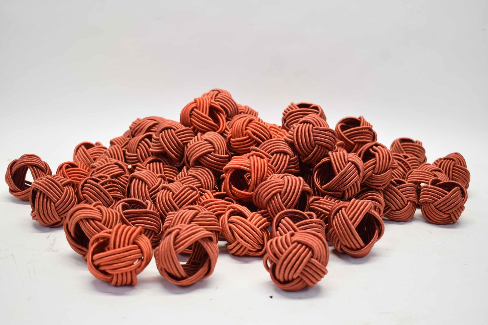 Large Group of William Sonoma Napkin Rings: Large Group of William Sonoma Napkin Rings, burgundy knot shaped, 82 in total, unmarked; used condition, wear/worn, few with pulls