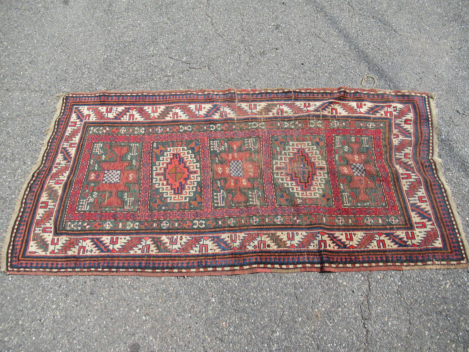 Caucasian Area Rug: Caucasian Area Rug in green, burgundy, red, beige and browns; used condition, wear/worn, repairs, measures 41 3/4" x 90"