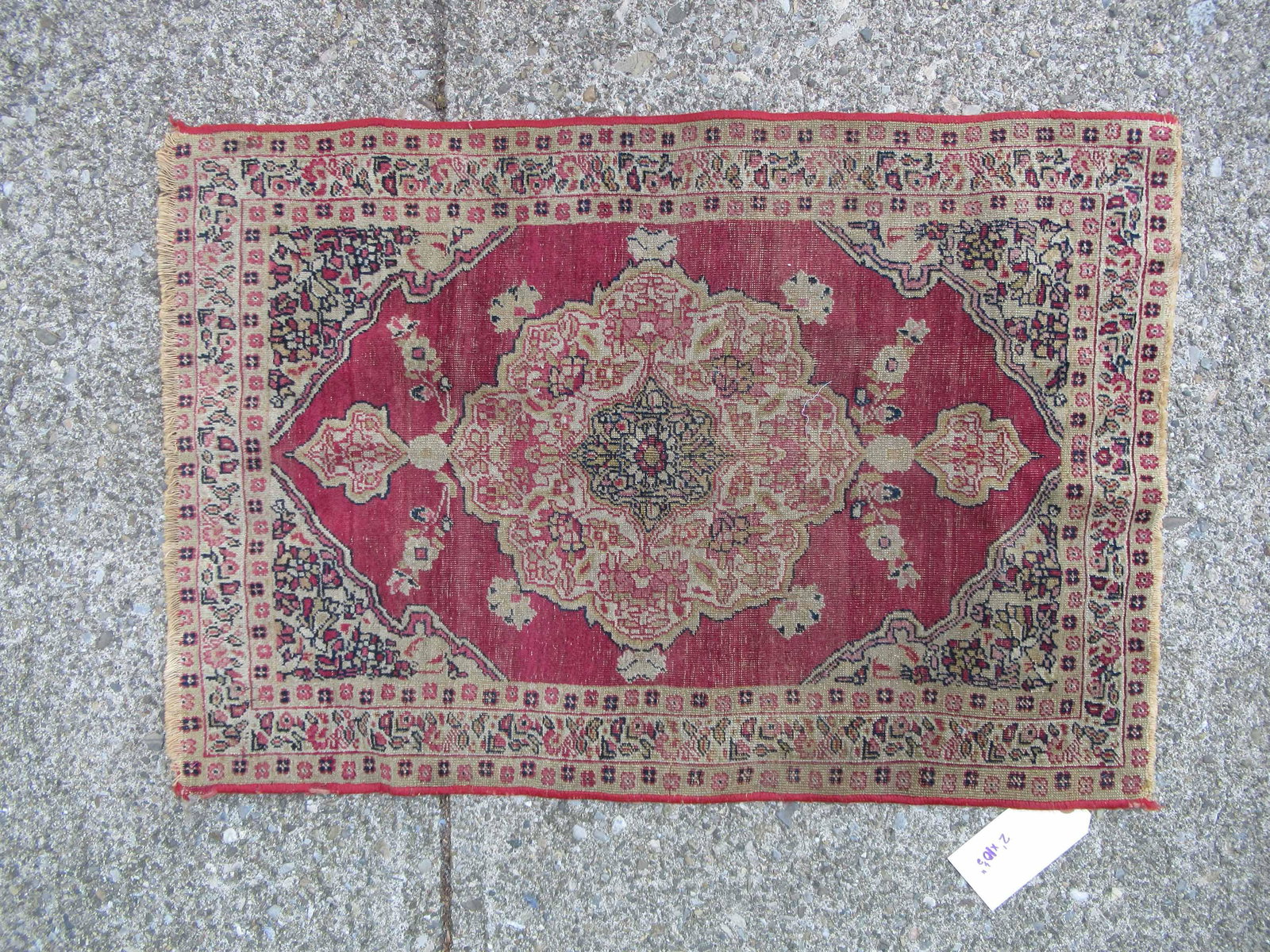 Oriental Throw Rug: Oriental Throw Rug having overall burgundy ground and central medallion; used condition, wear/worn, fading, measures 2' x 10 1/2" x 1' 11"