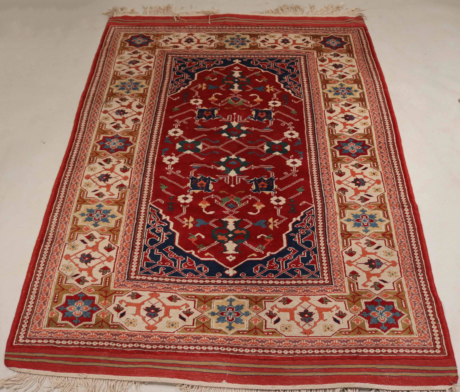 Turkish Moorish Star Area Rug: Worked in tones of red and cream. 4'10"w x 7'3"l Provenance: Property from a Prominent East Coast Collection.