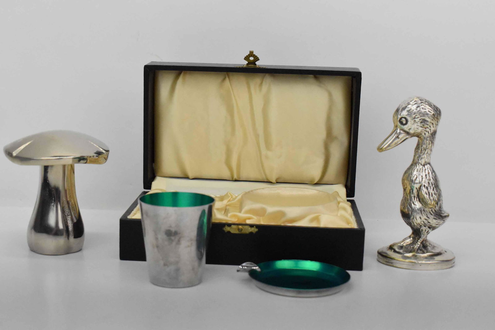 Meka Denmark Silverplate Ashtray & Cup Set: Meka Denmark Silverplate Ashtray & Cup Set with green enameled interior; together with silvered duck form bottle opener and a mushroom form corkscrew and bottle opener; used condition, wear/worn, box