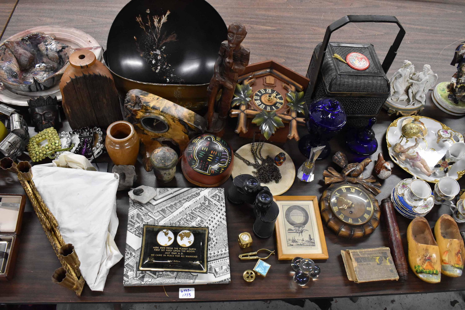 Large Group of Assorted Table Articles: Large Group of Assorted Table Articles including imari plates, Heco 8-day German cuckoo clock, elephant figural teapot, wooden sculptures, tapestry serving tray, wicker wedding box, gold tone Perini d