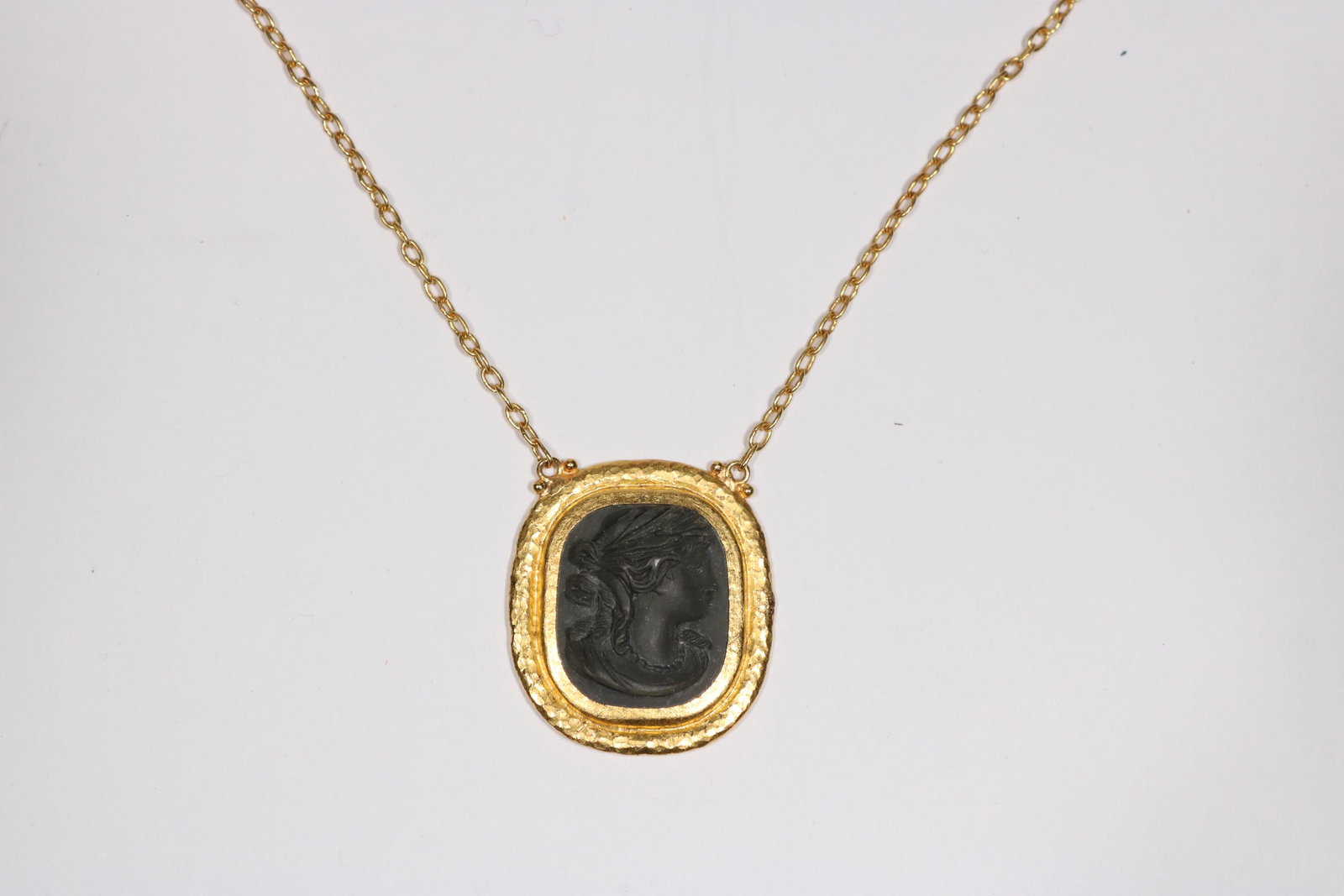 Gurhan Framed Lava Stone Style "Cameo" Necklace: A FRAMED LAVA STONE STYLE 'CAMEO' MEDALION NECKLACE, BY GURHAN with Gurhan pelican clasp METAL: 0.990 gold STONES: hardstone SIGNATURE: GURHAN, NU 535, and makers mark MARKS: 0.990 for 99% gold SIZE/D