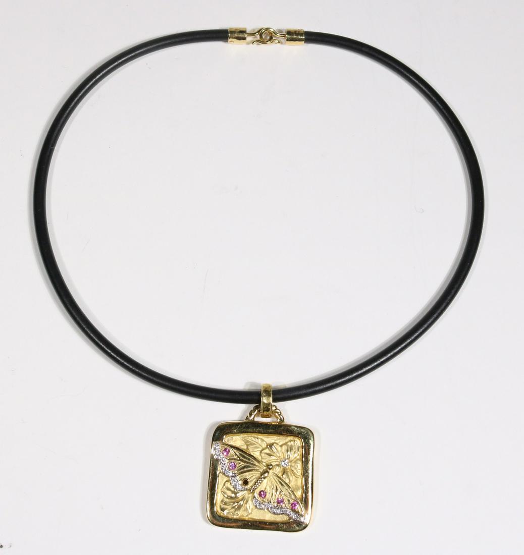 Seidengang Embossed Butterfly Square Enhancer: PINK SAPPHIRE AND DIAMOND EMBOSSED BUTTERFLY SQUARE ENHANCER, BY SEIDENGANG in 18k yellow gold with removable bail on rubber cord with 18k yellow gold clasp METAL: 18 Karat yellow gold STONES: 5 Pink 