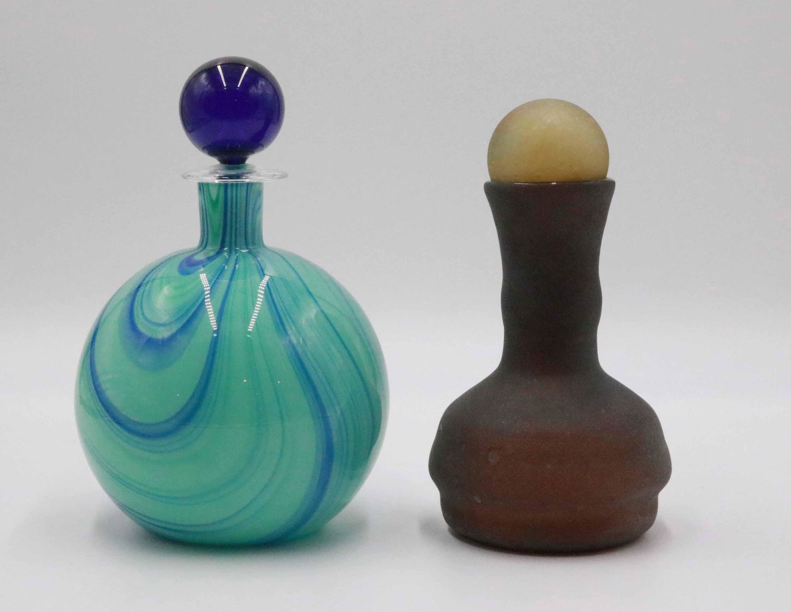 Carlo Moretti Blue Art Glass Decanter and Stopper: 9"h Together with a frosted green art glass decanter with stopper which appears to be unsigned. Property from a Short Hills, NJ and San Francisco, CA Private Collection