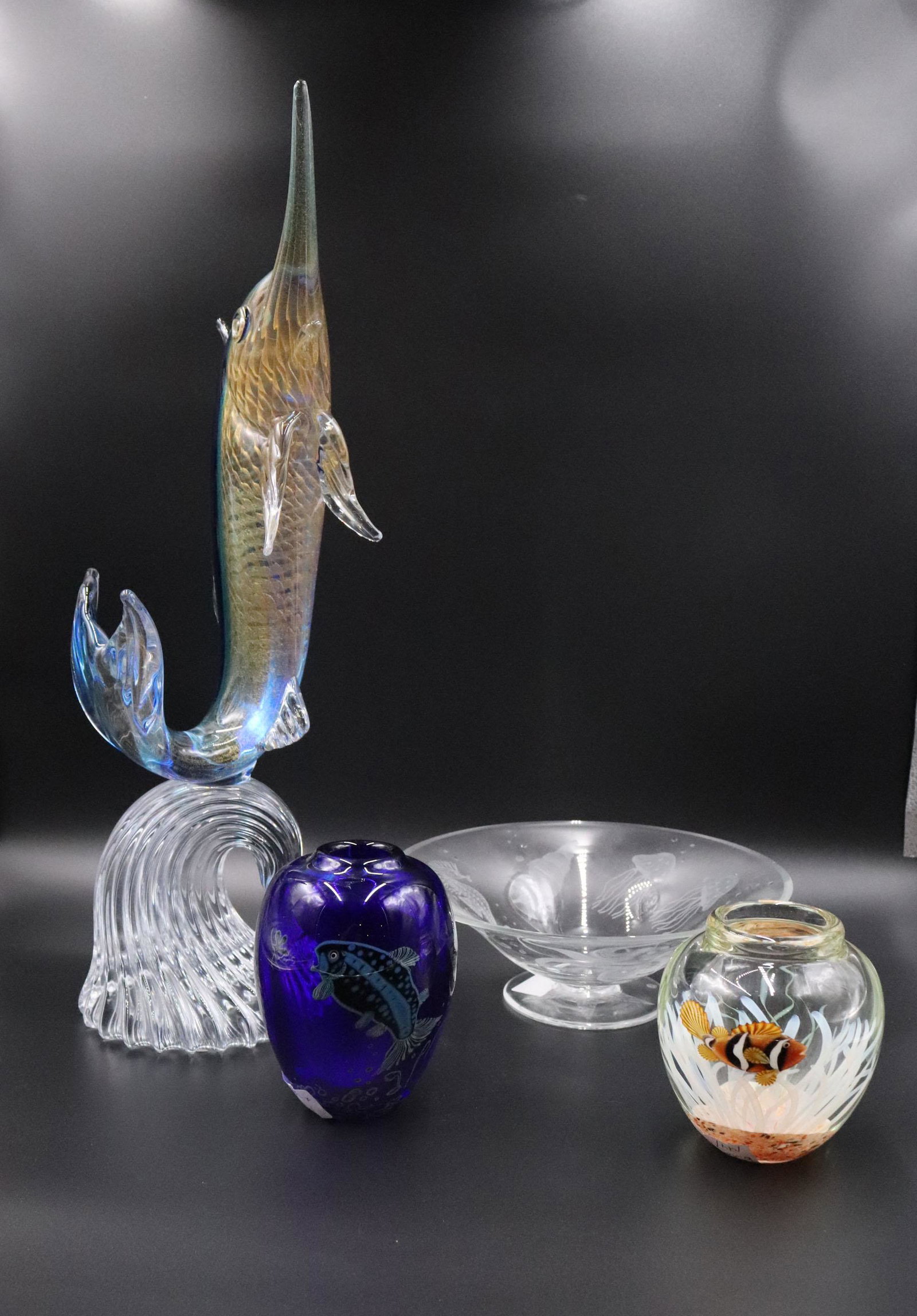 Four Art Glass Fish Decorated Table Articles: Comprising, two Orient and Flume Fish decorated vases, a Sardinia crystal sailfish sculpture, and a frosted and clear glass footed bowl. Chip to bowl. 5"h, 6"h, 22"h, and 3-3/4"h x 10-1/2"dia. Propert