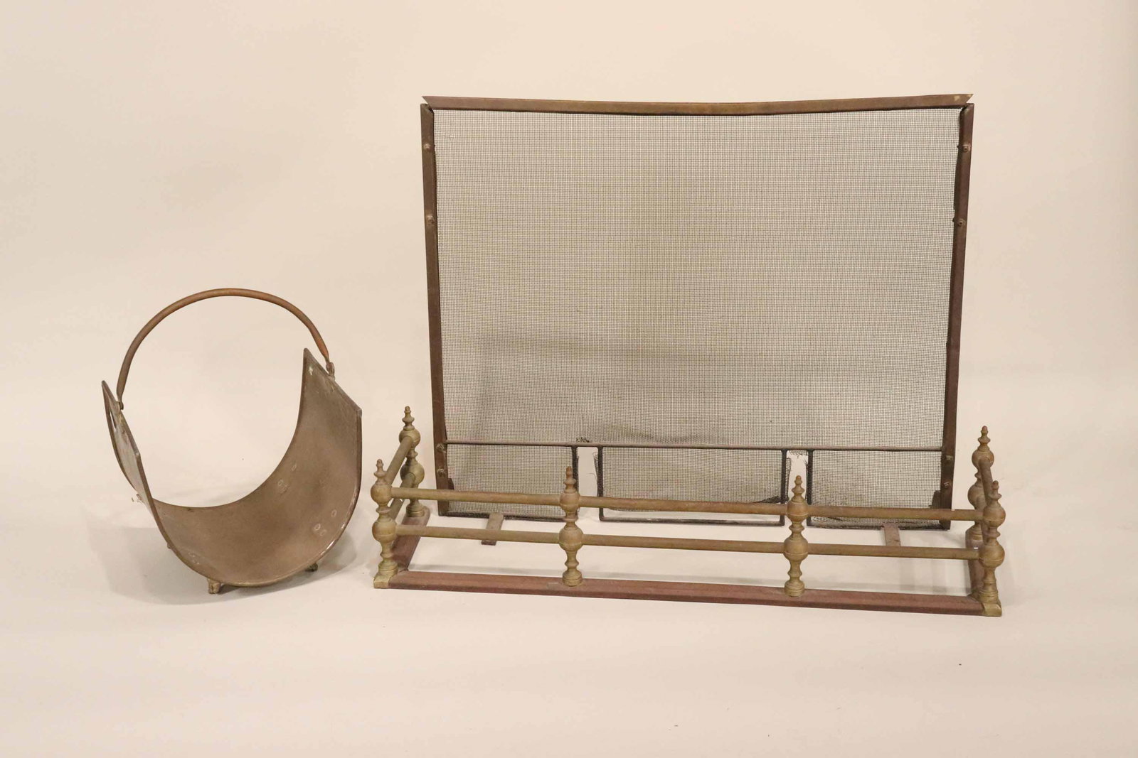 Group of Brass Fireplace Equipment: Comprising, a fender, a firescreen, and a log holder. Wear and surface distress. Firescreen: 31-1/2"h x 37"w