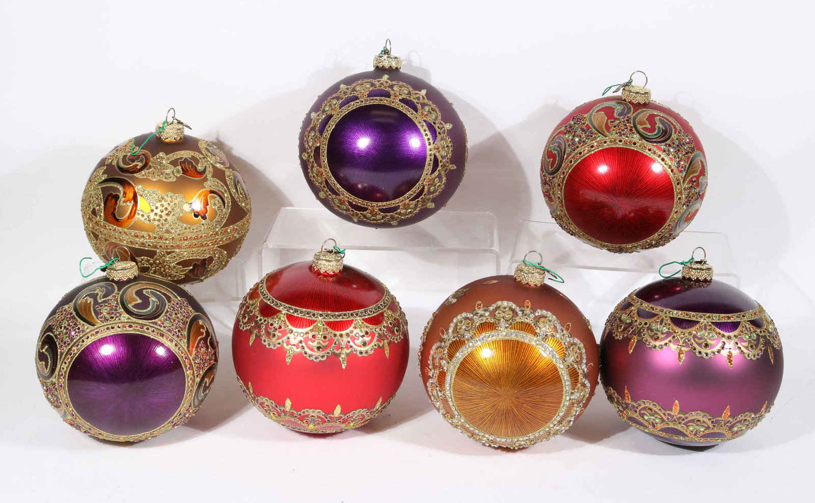 Seven Jay Strongwater Round Crystal Ornaments: Comprising, two red, two gold, and three purple, all with original boxes. Apx. 4-1/2"dia. to 5-1/2"dia. Property from a Short Hills, NJ and San Francisco, CA Private Collection