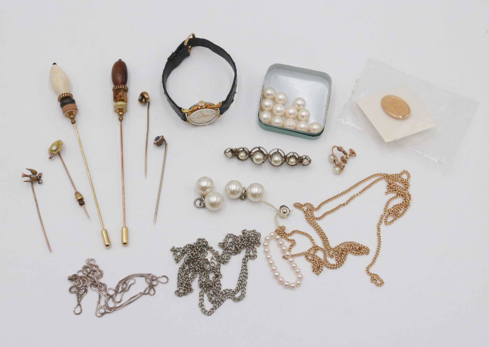 Movado Gold Filled Ladies Wristwatch: Gold chain unmarked, sterling chain, unmarked silver chain, a service pin, pearls, bits, and hat pins.