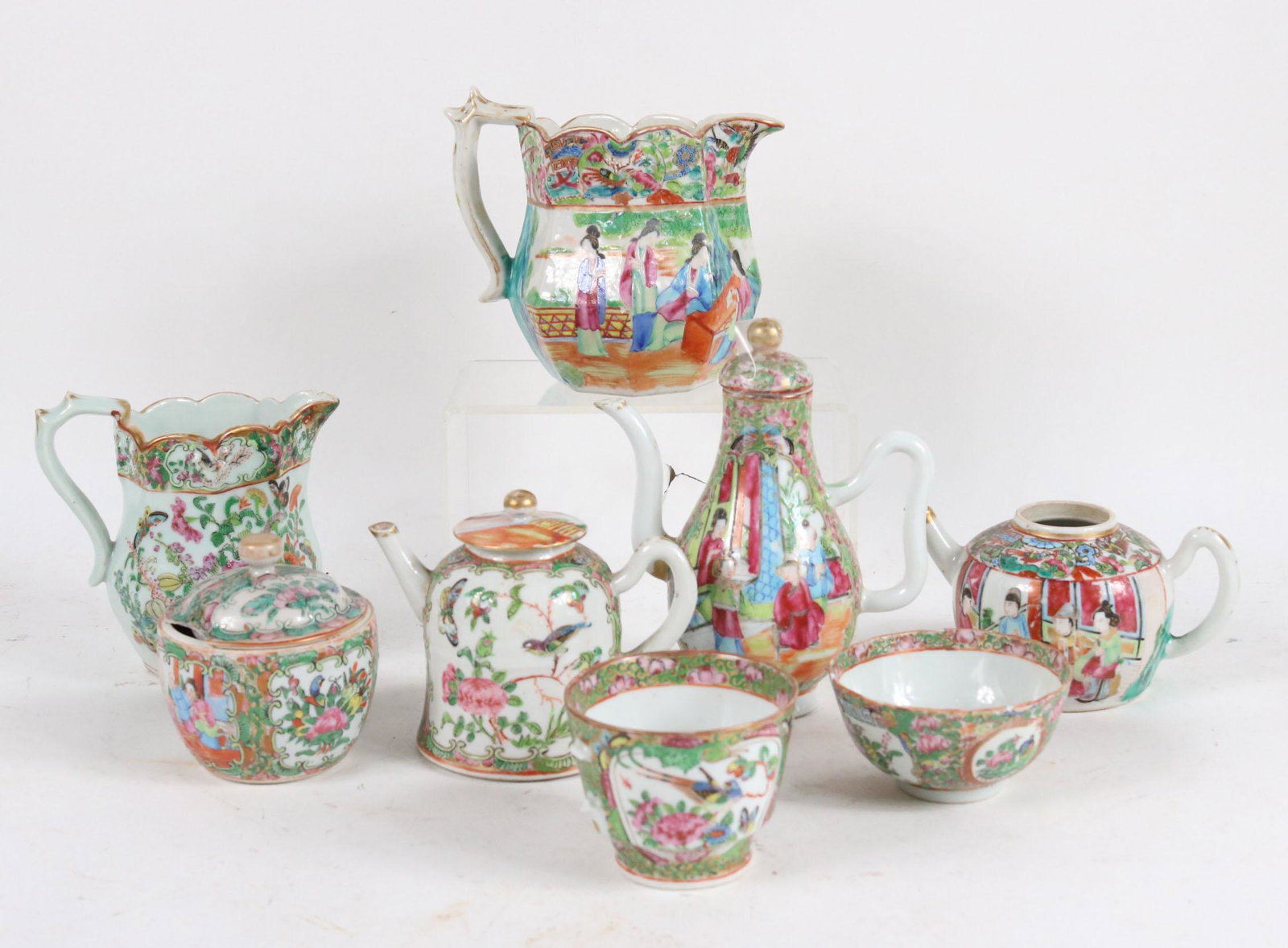 Eight Chinese Rose Medallion Table Articles: Comprising, three teapots, two pitchers, a sugar bowl, and two teacups. 8 pieces Losses, chips, cracks. Tallest: 6-3/4"h