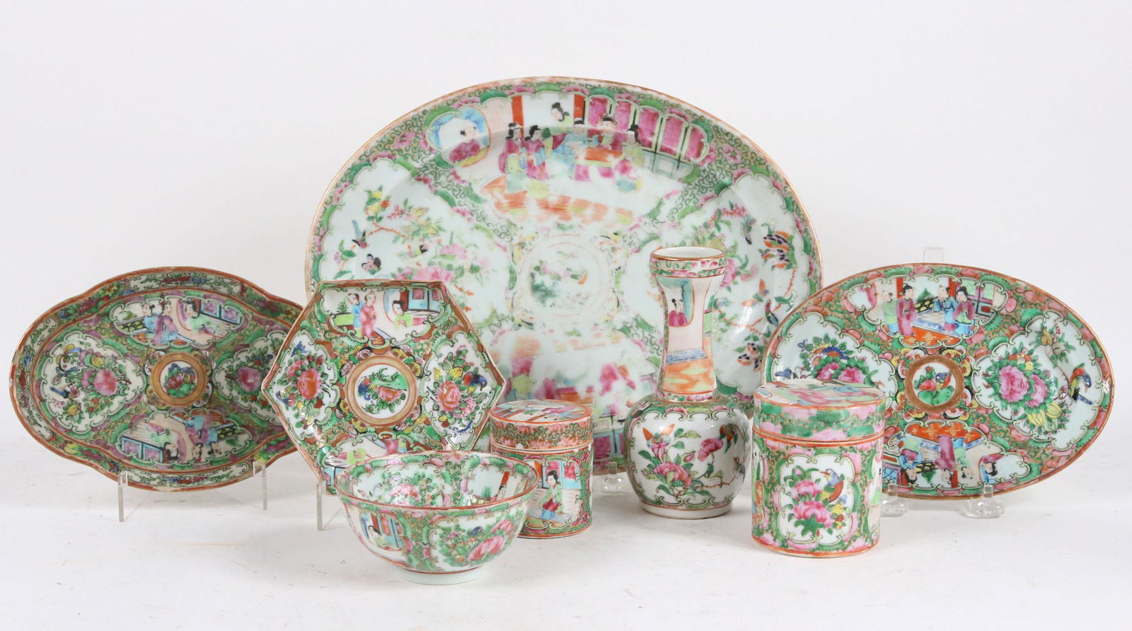 Eight Chinese Rose Medallion Table Articles: Comprising, three oval platters, a hexagonal plate, two covered jars, a vase, and a rice bowl, Largest: 12-3/4"h x 9-1/2"w Losses, chips, cracks.