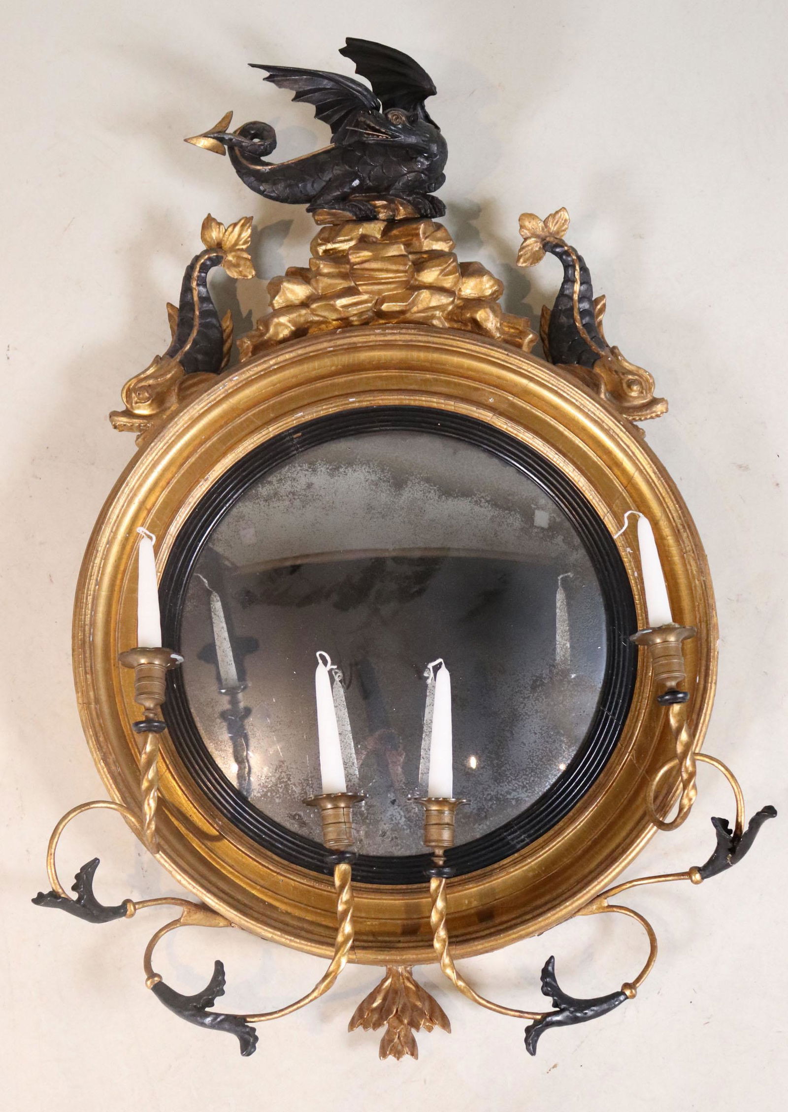 Regency Giltwood Dragon-Decorated Convex Mirror: English, 19th C., with for candle arms, part-ebonized, with dragon and dolphin form pediment. Cracks, losses, wear, losses to mirror plate. 42"h x 26"w x 7"d
