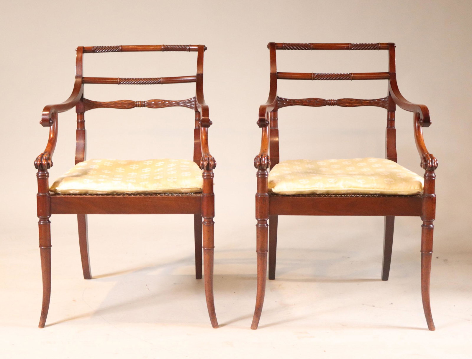 Pair of Regency Carved Mahogany Armchairs: English or Irish, early 19th C. 34-1/2"h x 22"w (over arms) x 18-1/2"w x 18"d (seat) Provenance: Property from the Estate of Robert K. Johnson of Maine and South Carolina