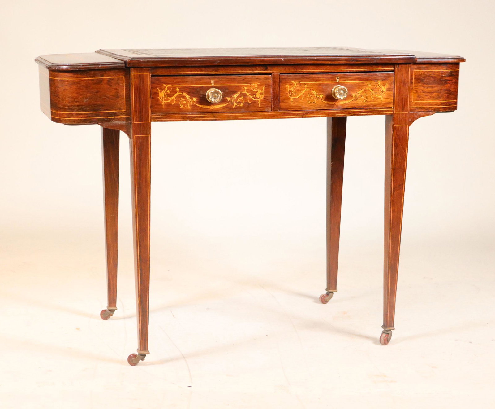 Edwardian Inlaid Leather-Inset Gentleman's Desk: English, c. 1900. Fitted with drawers, on casters. 29"h x 41-1/4"w x 18"d
