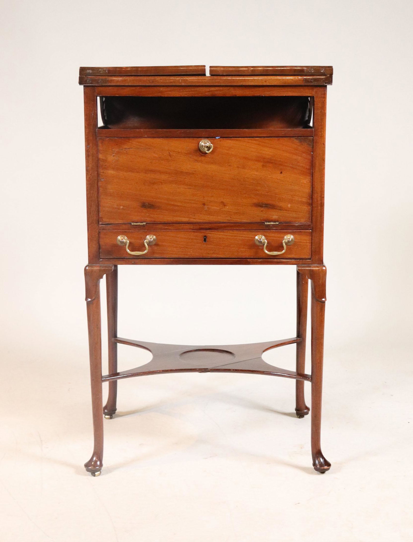 George III Carved Mahogany Beau Brummel: English, 18th C. with removable leather tray revealing fitted surface backed by looking glass 35"h x 20-1/2"w (closed) x 40"w (open) x 15-1/2"d Provenance: Property from the Estate of Robert K. Johnso