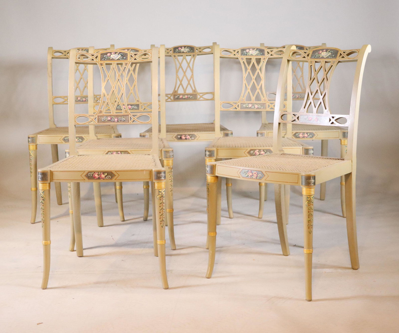 Seven George III Style Painted Side Chairs: 20th C. with caned seats, en suite with octagonal table. 36"h x 18"w x 16"d seat depth Provenance: Property from the Estate of William Hodgins, Boston, Massachusetts