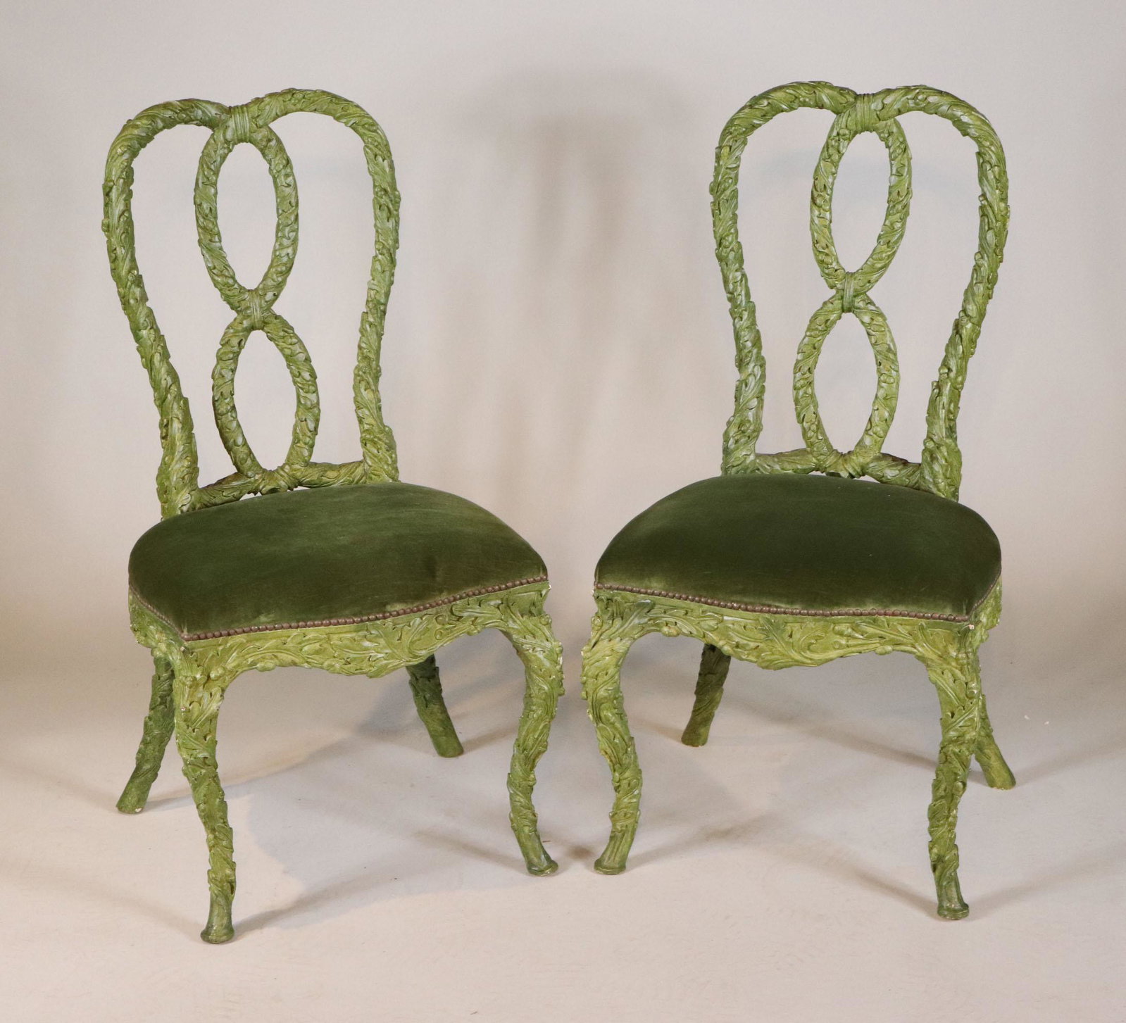 Pair of Baroque Style Verdigris Side Chairs: English taste, 20th C. leaf-carved. 41-1/2"h x 21"w x 17" seat depth Provenance: Property from the Estate of William Hodgins, Boston, Massachusetts