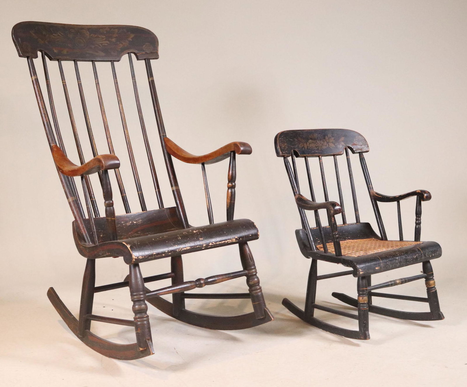 Two Empire Black Painted "Boston" Rocking Chairs: Massachusetts, 19th C. comprising one Stencil-Decorated adult and one child's rocker. Losses to paint. 43"h and 25-1/2"h