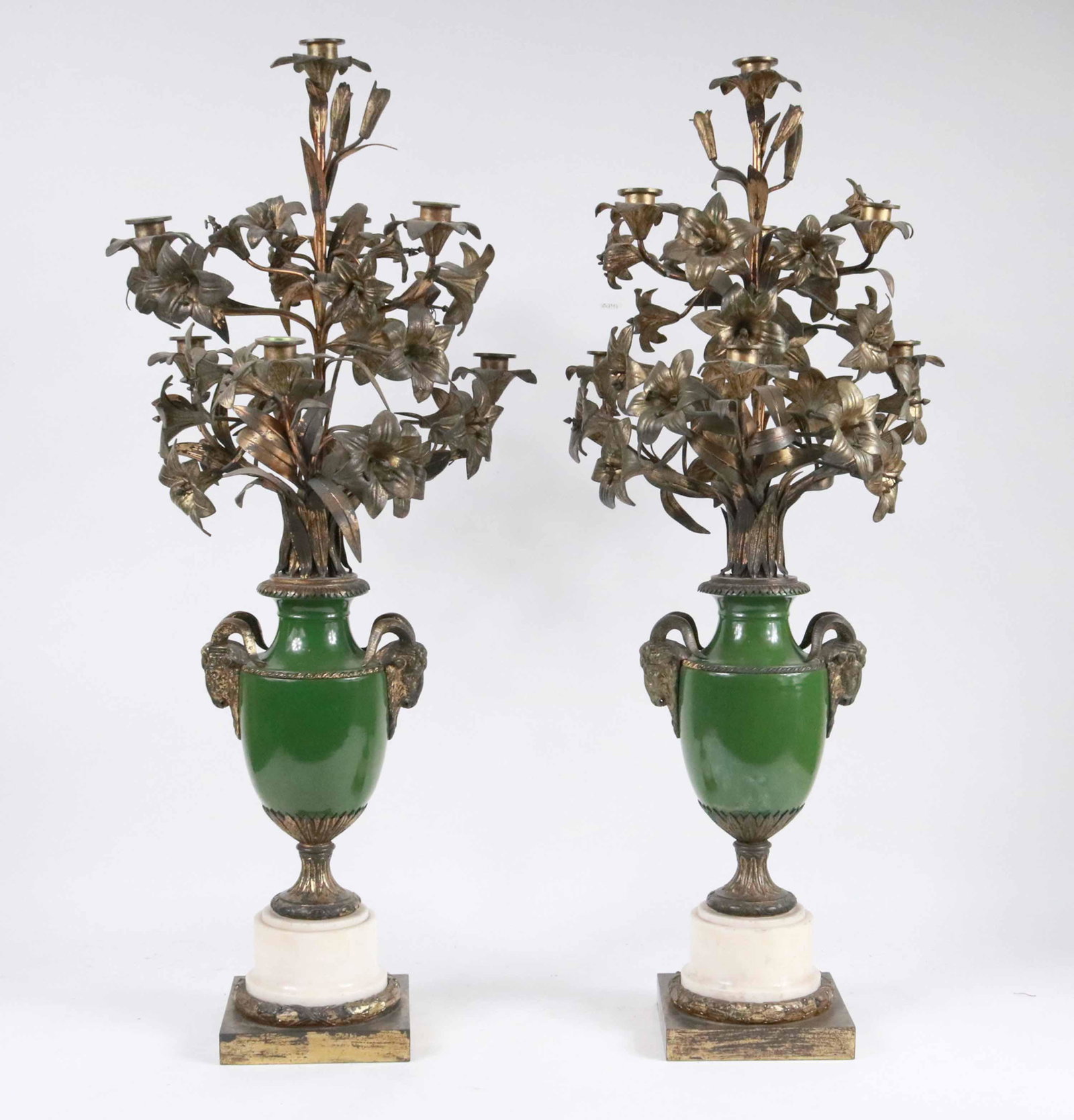 Pair of Neoclassical Style Gilt-Metal Garnitures: 20th C. gilt-metal mounted on green glazed porcelain on a stone plinth. Scratches and surface distress. 33-1/2"h