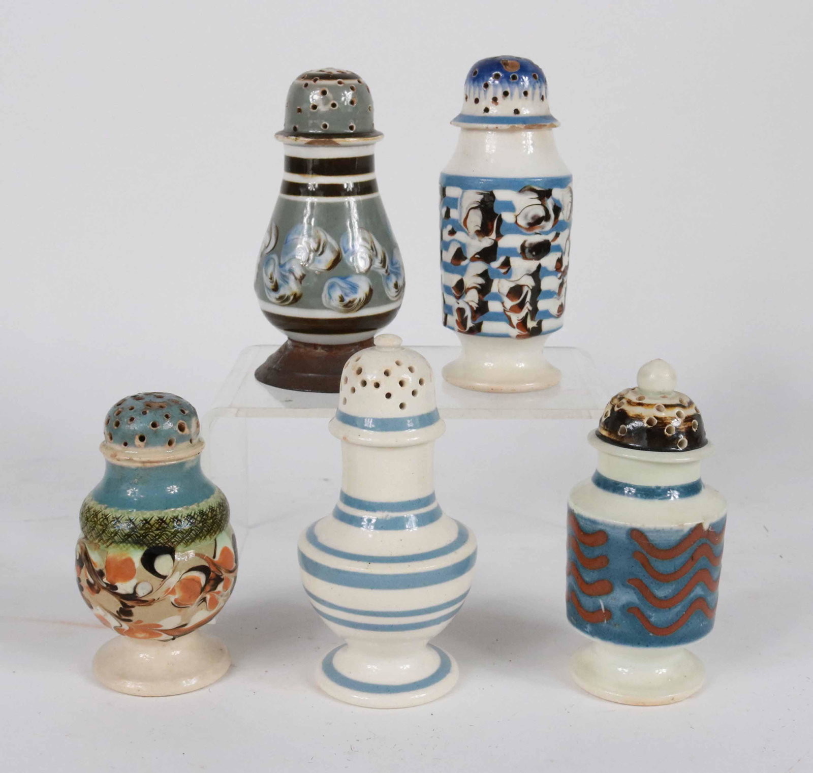 Group of Five Mochaware Pepper Pots: English, 19th C. From: 3-3/4"h to 4-3/4"h Some chips and repairs. Provenance of Tin Base: William Lewman Antiques, Fitzwilliam, NH Blue Banded: Bea Colten Antiques, Easton, PA Damaged Foot: Nathan Lie