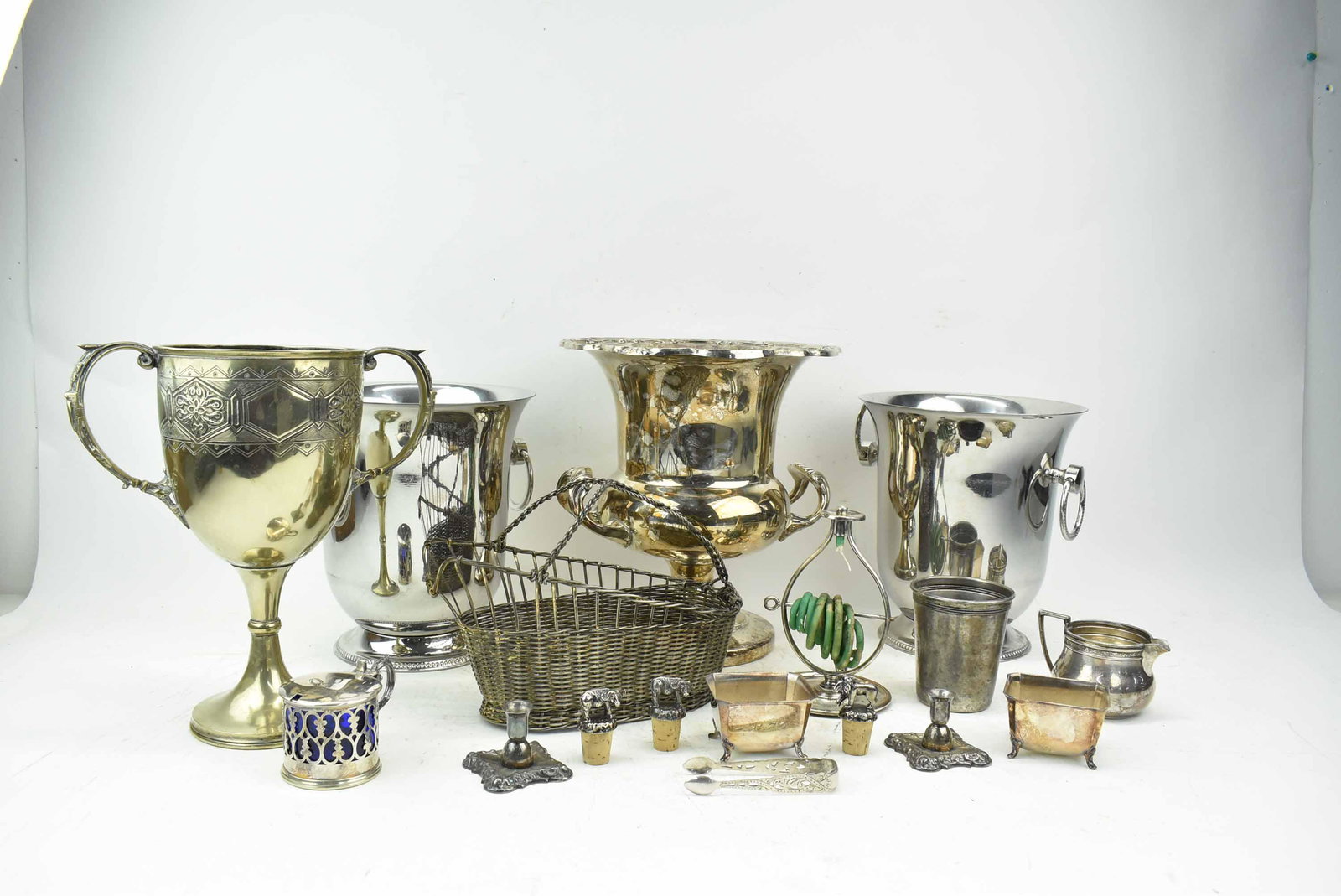 Group of Silverplate Table Articles: Group of Silverplate Table Articles including a footed champagne bucket, two handled large trophy/cup, antique wax jack, Wm Mounts creamer, 2 footed salt cellars, condiment jar with cobalt glass liner