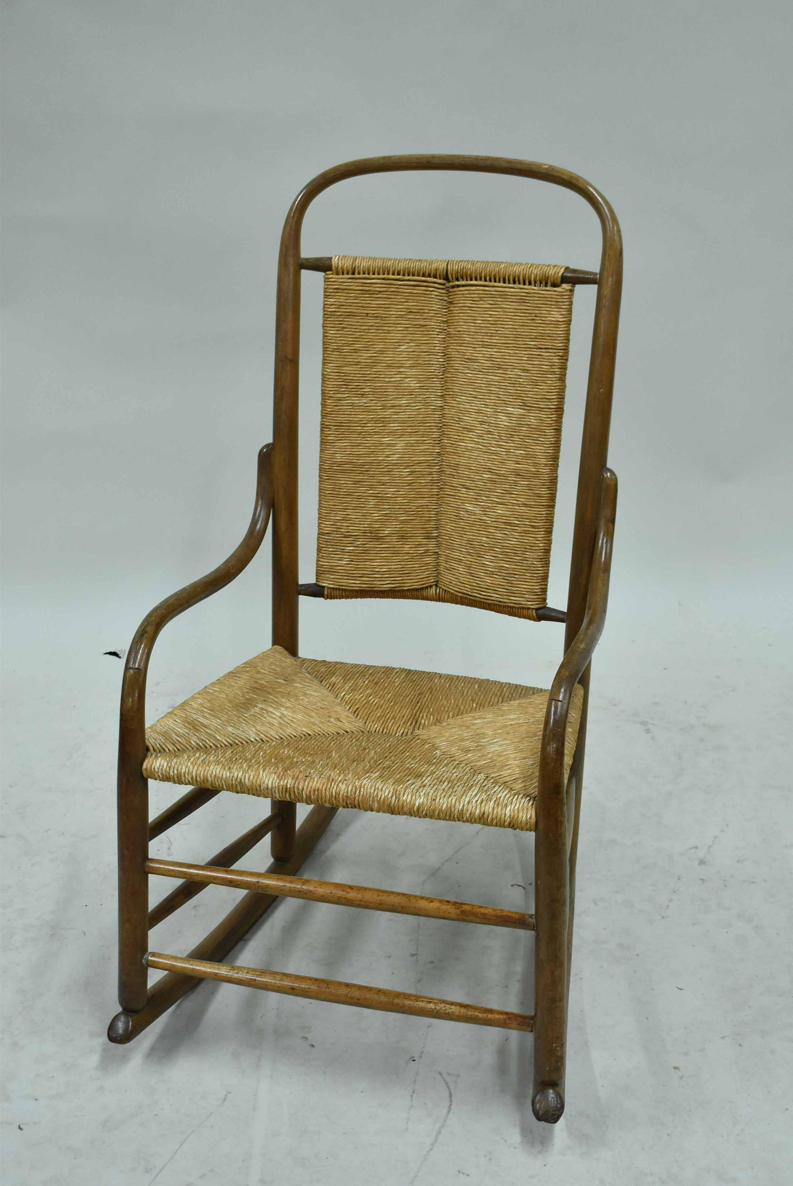 Vintage Bentwood Rocking Armchair: Vintage Bentwood Rocking Armchair having rush seat and backrest. Used condition. 37" tall x 20" wide