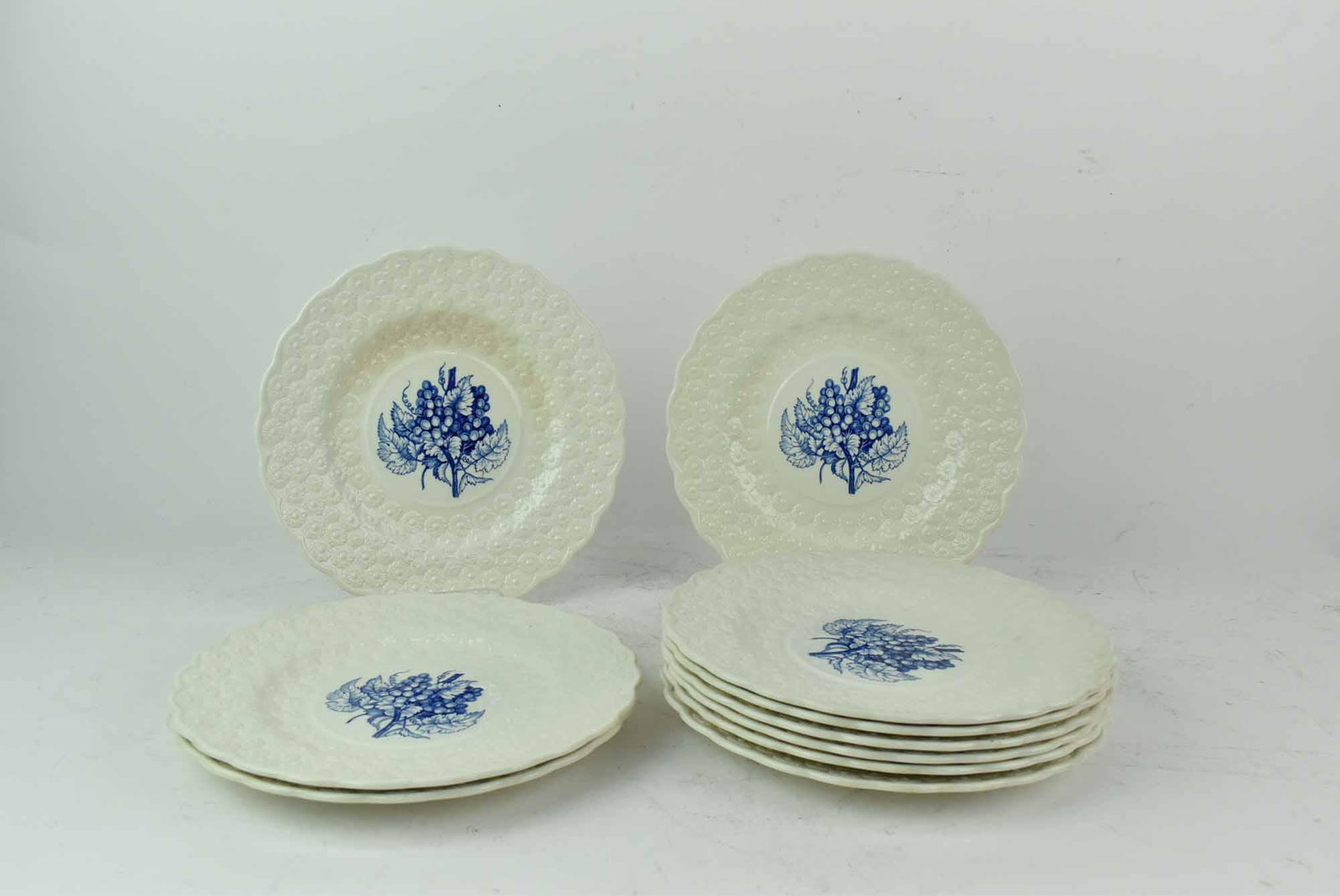 10 Copeland Spode Luncheon Plates: 10 Copeland Spode Luncheon Plates having embossed floral band, scalloped rim and blue grapevine transfer print center; used condition, wear/worn, crazing, discoloration, utensil marks, each measure 9 