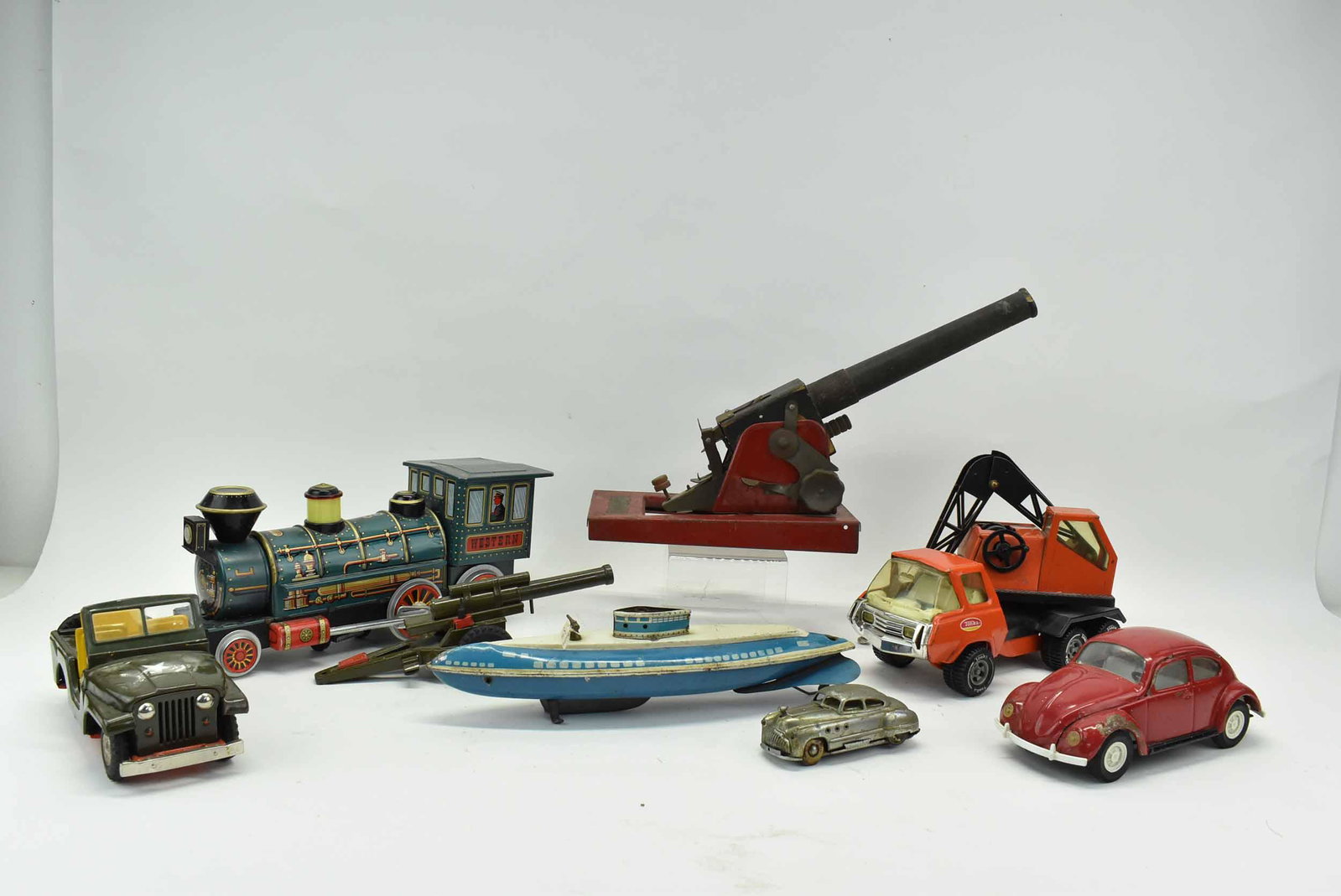 Group of Assorted Vintage Metal Toys: Group of Assorted Vintage Metal Toys including a Volverine submarine, Western Train Locomotive Engine, Army Jeep with Artillery Gun Trailer, TONKA Volkswagen VW Red Beetle, TONKA Truck Swivel Crane wi