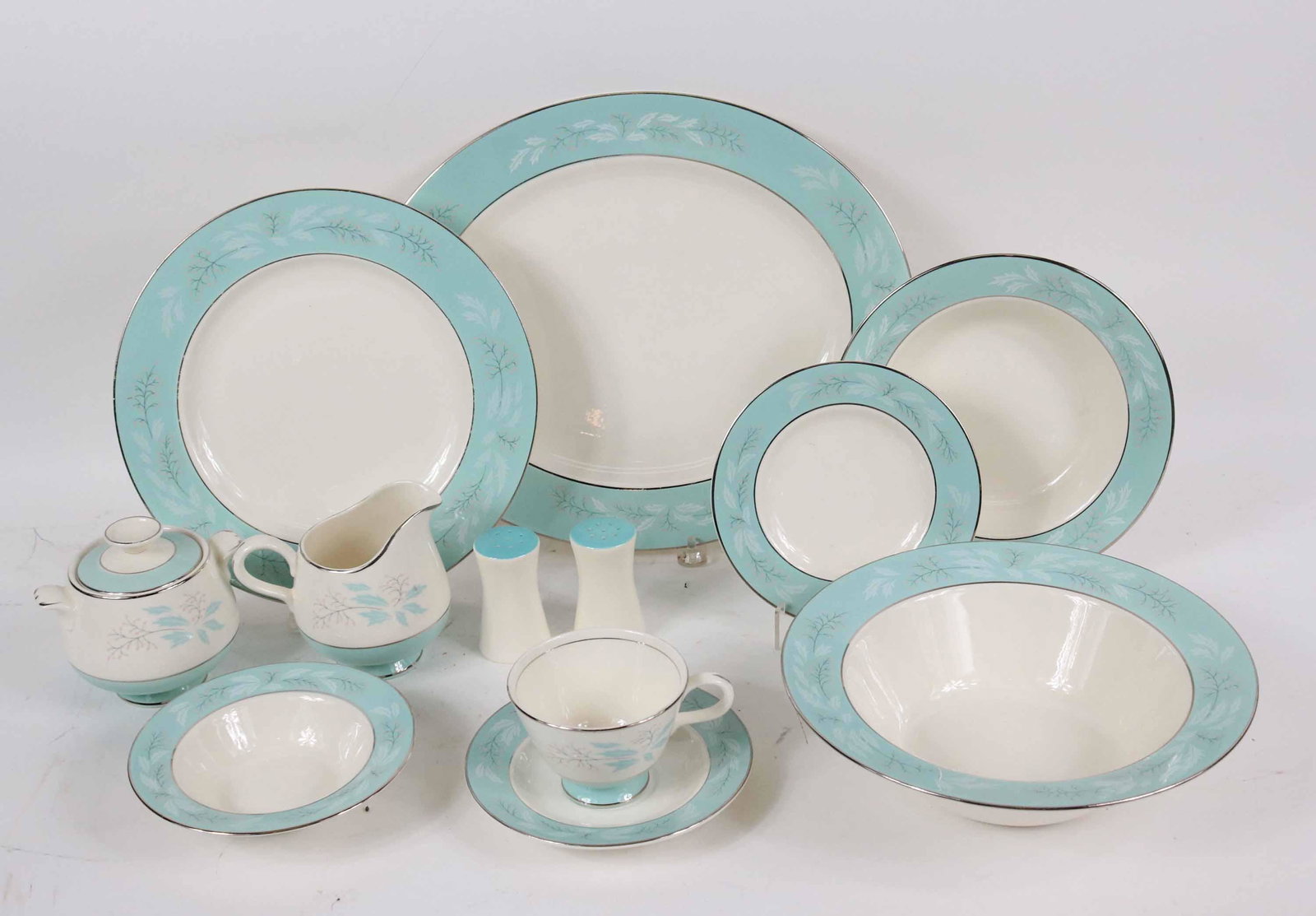Set of Blue-Floral Porcelain Dinnerware: Comprising, 8 dinner plates, 7 soup bowls, 8 fruit bowls, 7 teacups and 8 saucers, 8 bread and butter plates, an open vegetable bowl, an oval platter, salt and pepper shakers, a creamer, and a covered