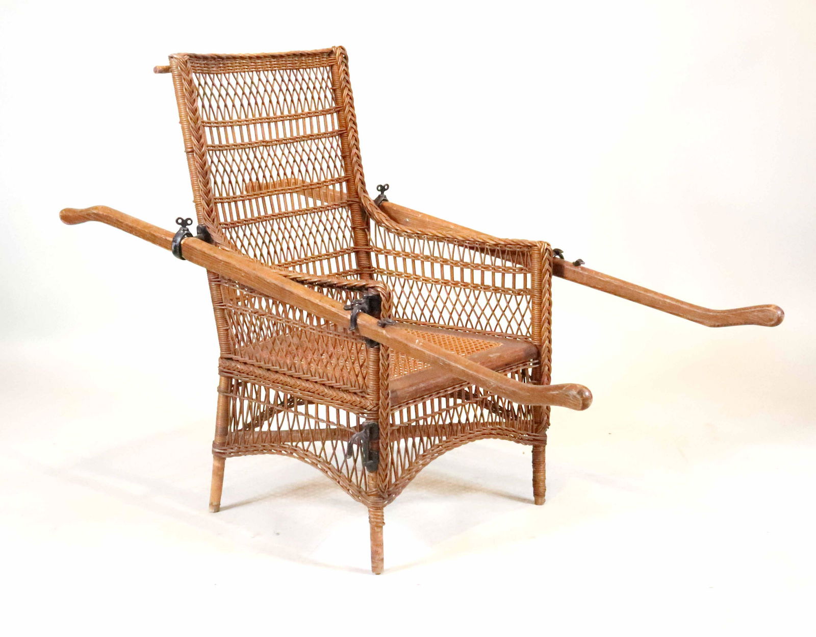 Campaign Wicker and Caned Sedan Chair: Probably English, 19th/20th C. with oak rails. Some losses and wear. 37-1/2"h x 26"w x 4'8"d