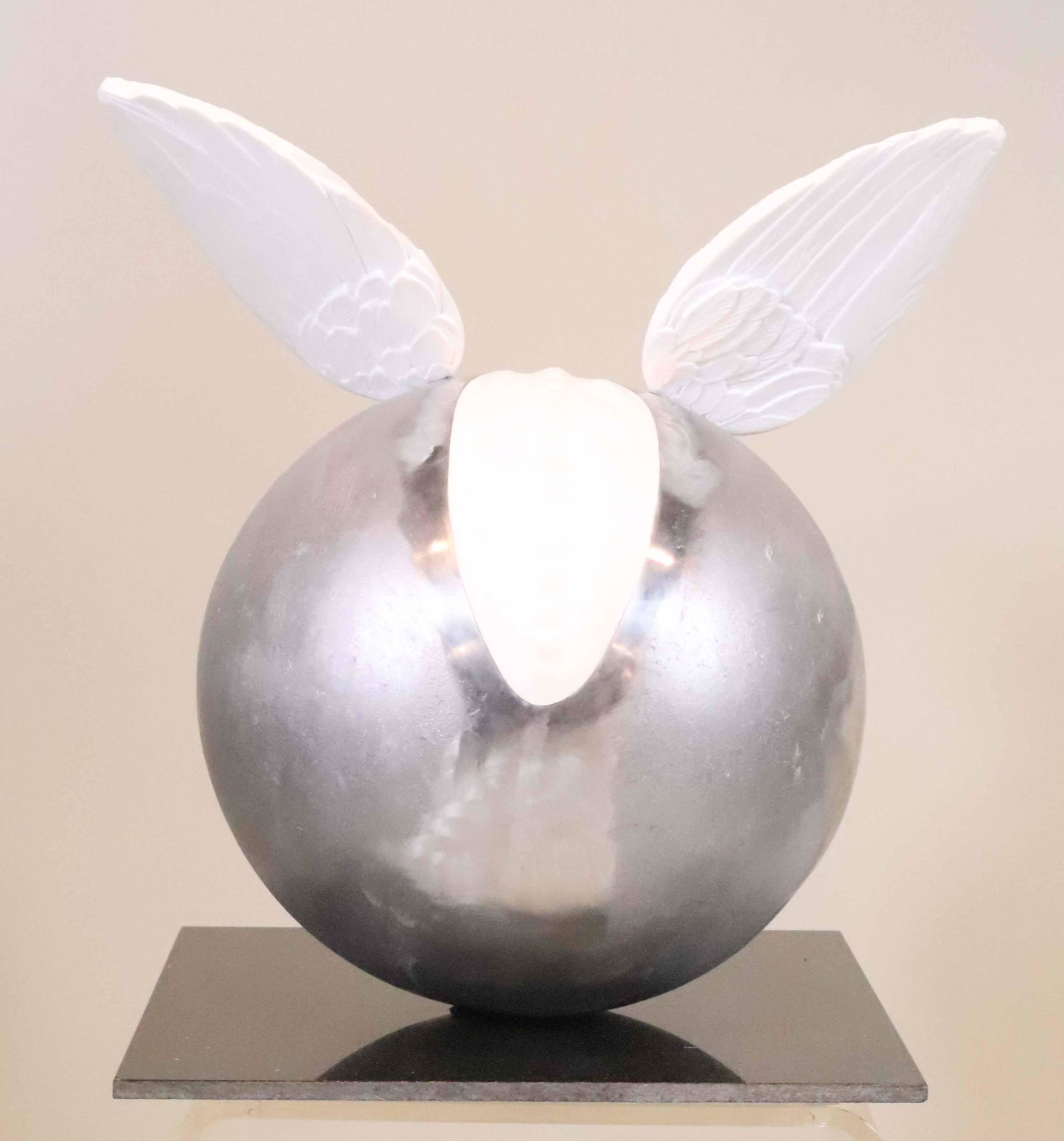 Icaro I, Oriano Galloni, Metal & Stone Sphere: (Italian, b. 1970) White Metal Sphere Mounted with carved stone Wings. Apx. 21"h x 20-1/2"w x 15"d Property from a Short Hills, NJ and San Francisco, CA Private Collection