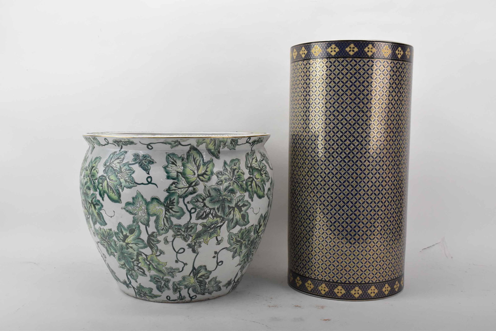 Chinese Porcelain Fishbowl Planter: Chinese Porcelain Fishbowl Planter with exterior enameled foliage and interior koi fish design. Together with a porcelain umbrella stand having blue and gold geometric pattern; used condition, wear/wo